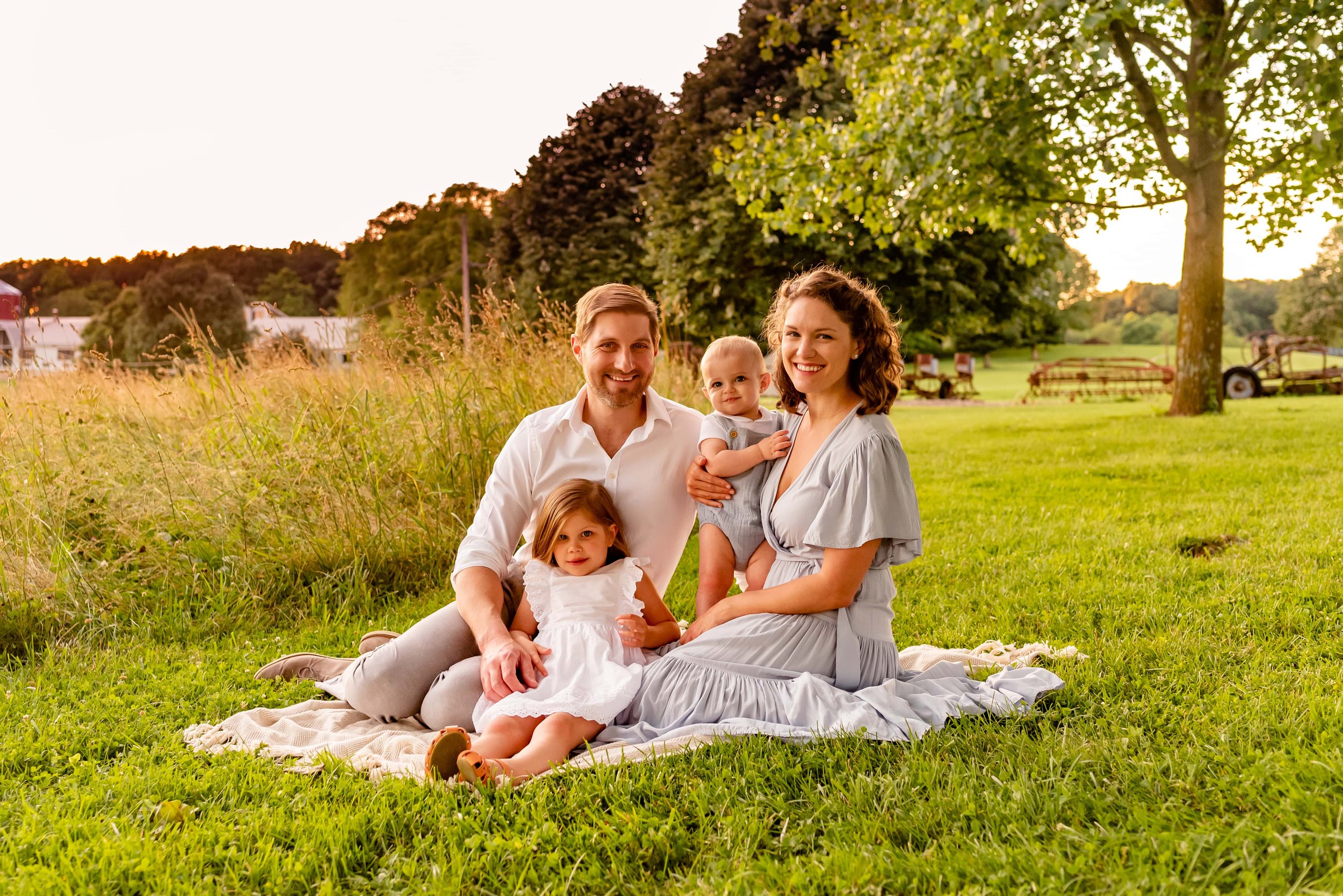 Maryland family of four sitting in a field