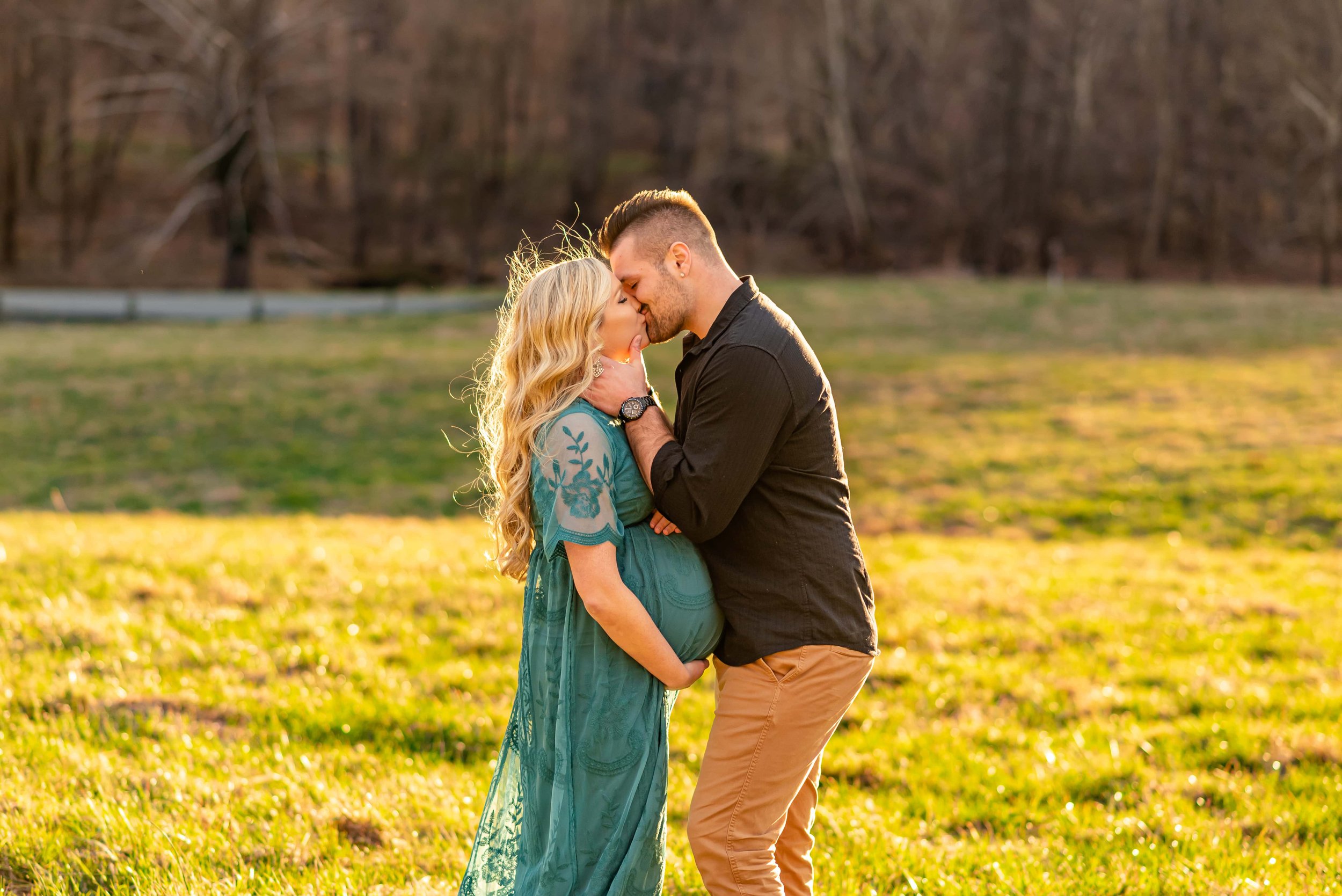 Maryland Maternity photo of couple kissing in a field