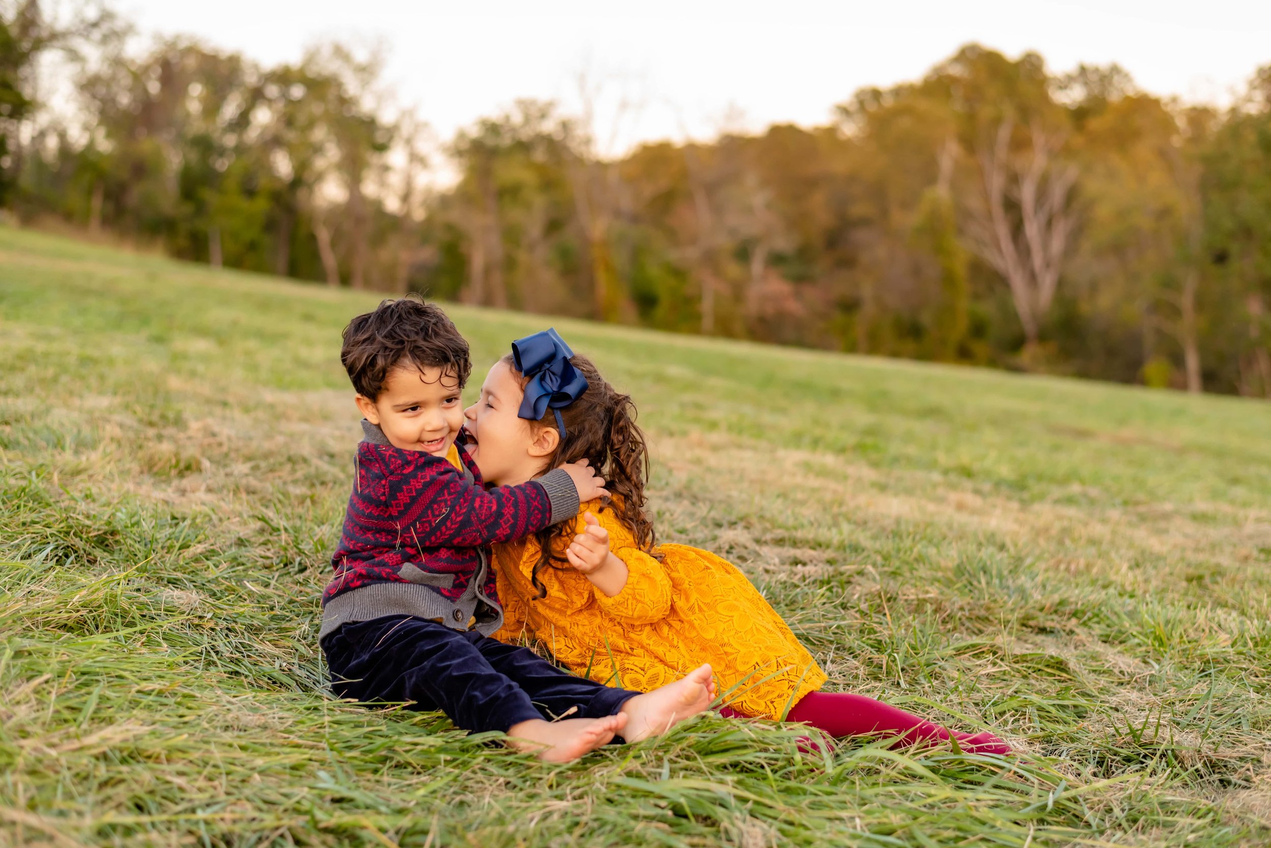 Photo of Maryland Brother and Sister sitting in a field