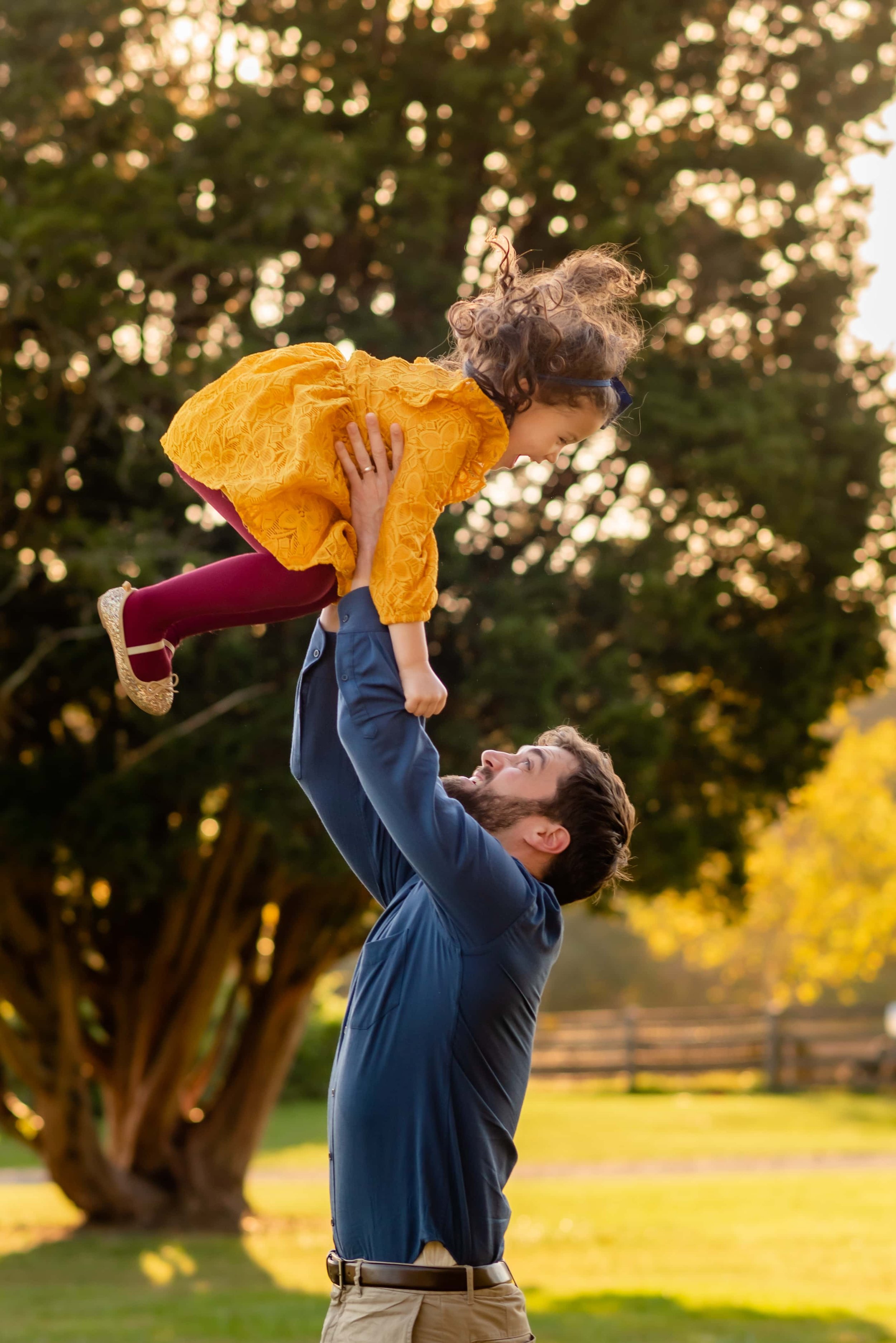 Photo of Maryland Dad Tossing Daughter in the Air