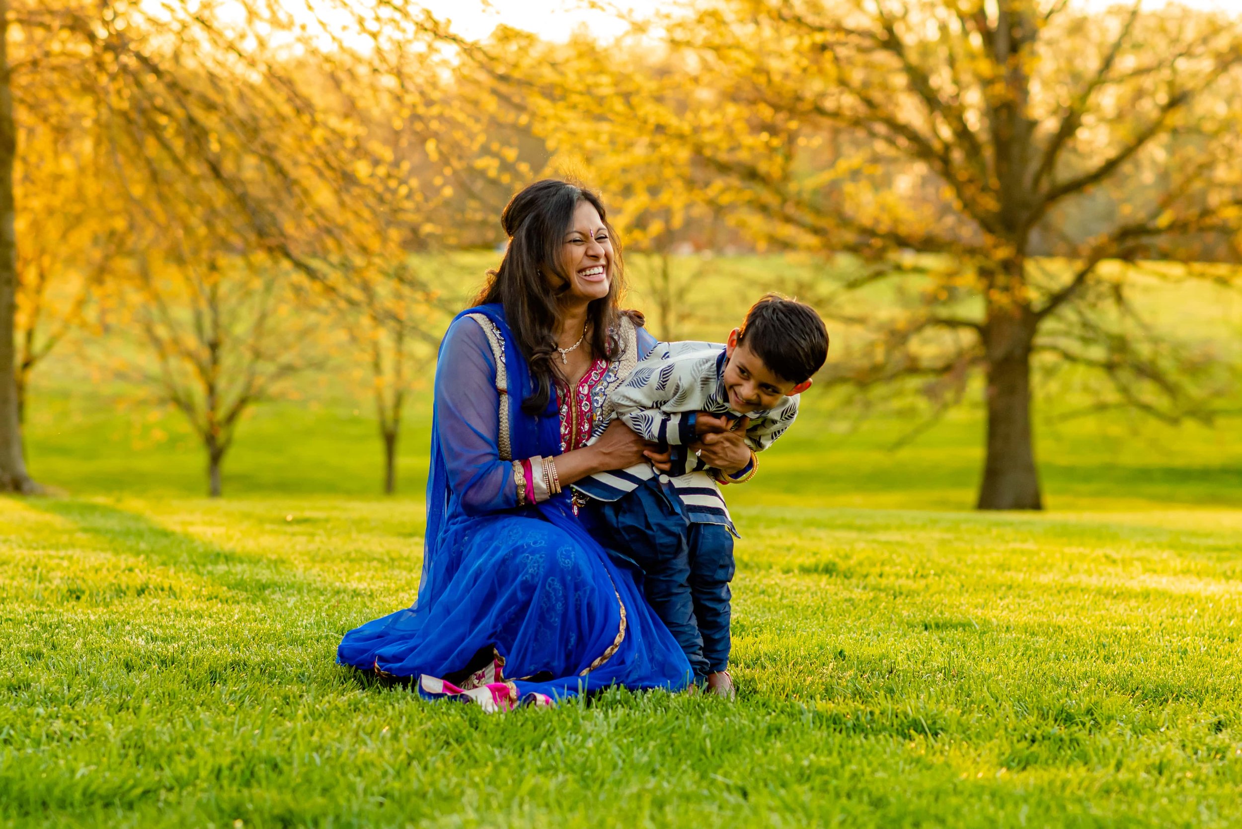 Maryland family photos with mom and son giggling in a field