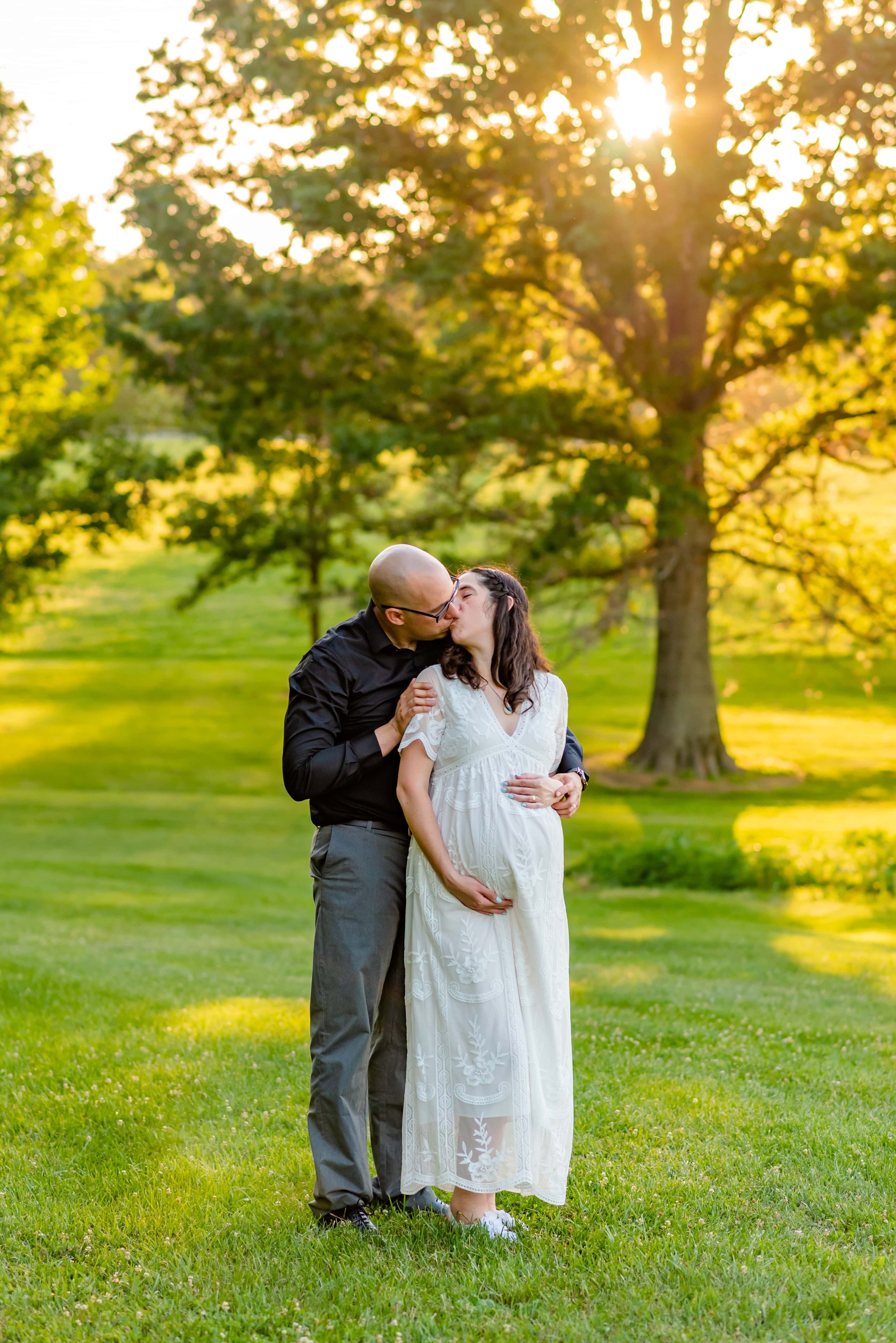 Maryland Maternity couples photo of man and woman standing in a field kissing