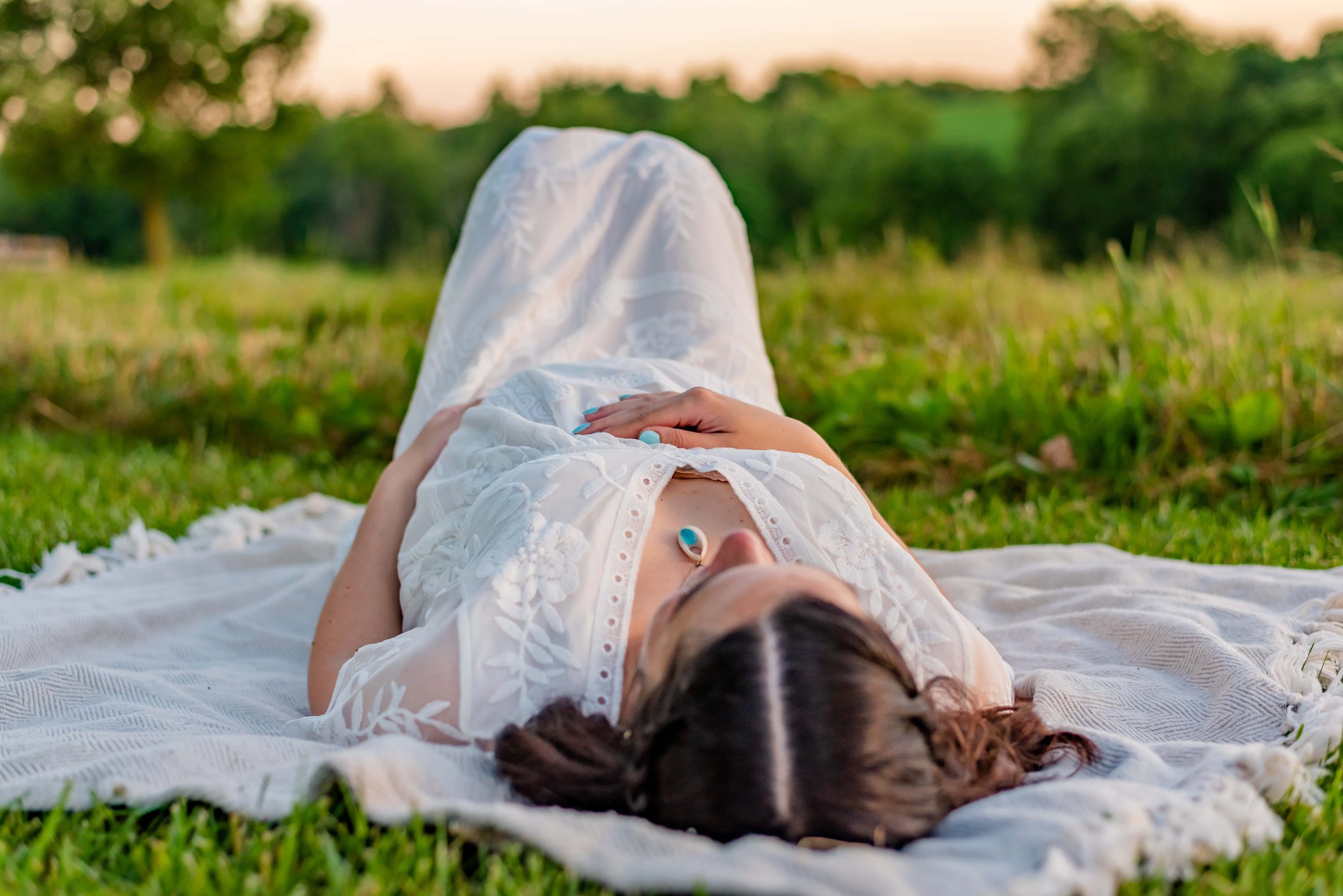 Maryland Maternity photoshoot of pregnant woman laying on a blanket