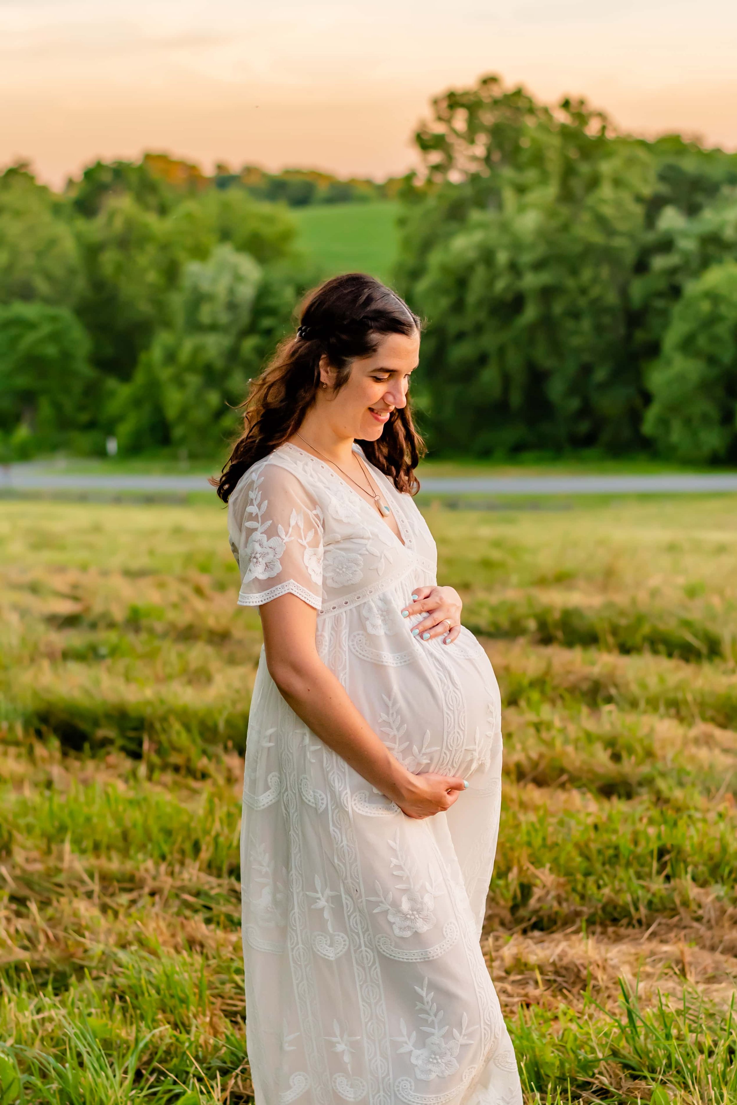 Maternity photo of woman in Maryland standing in a field