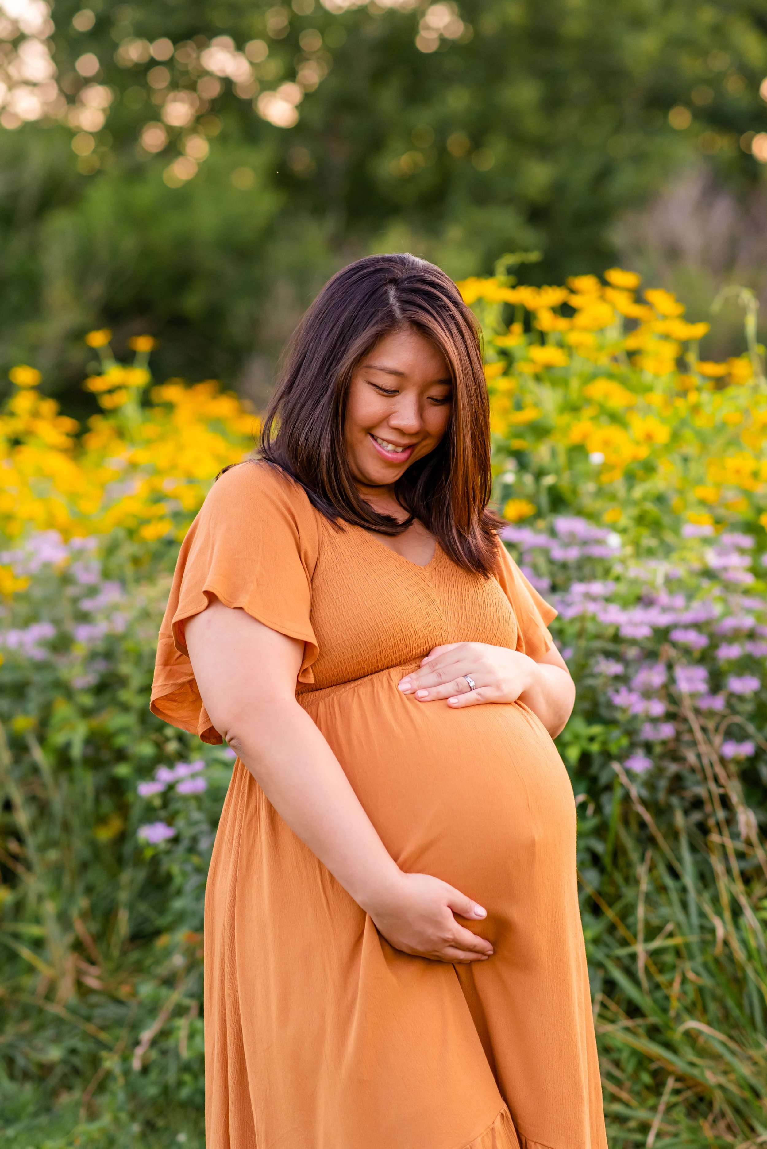 Maryland Maternity Photo of woman holding belly and smiling