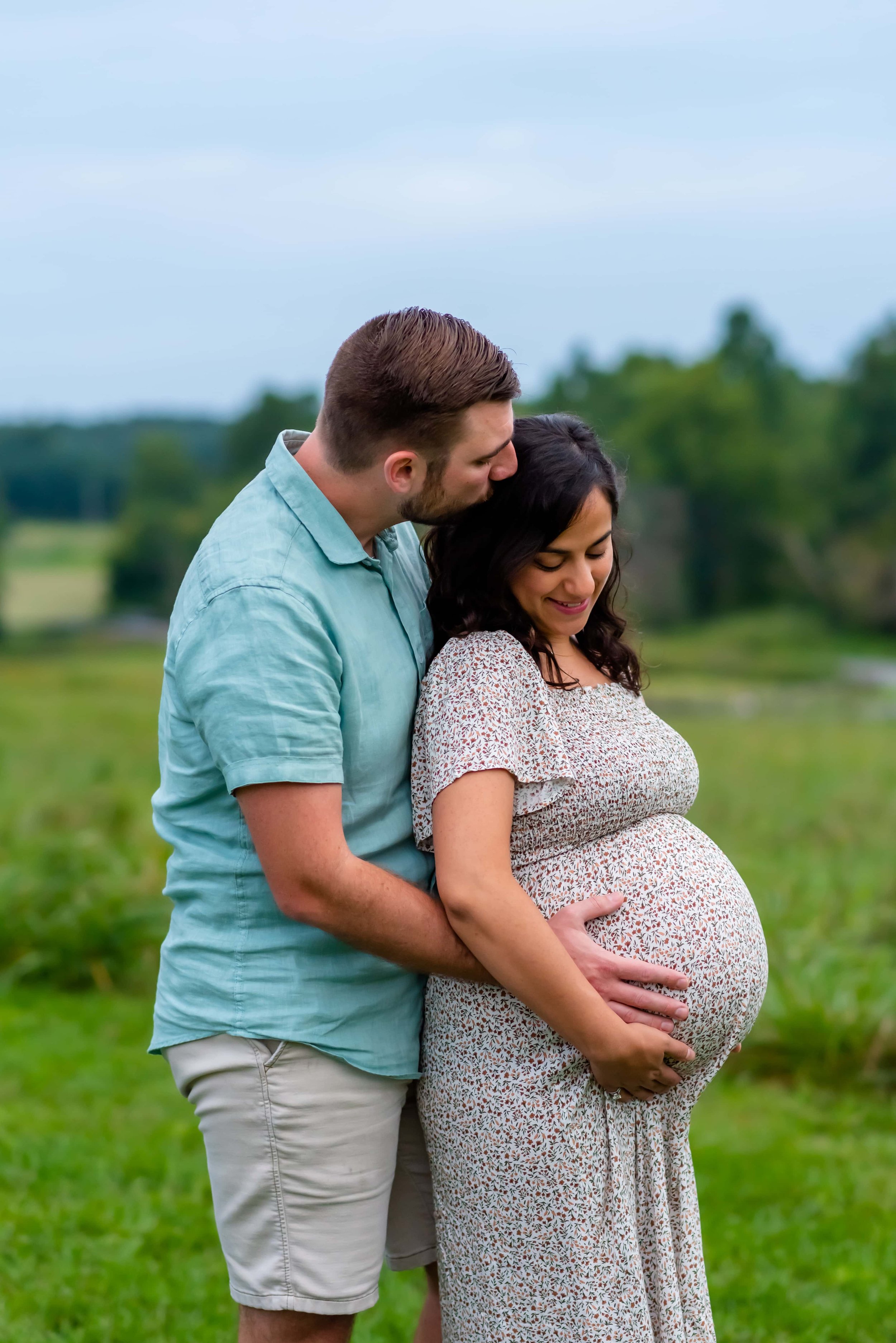 Maryland Maternity photo of couple standing in a field