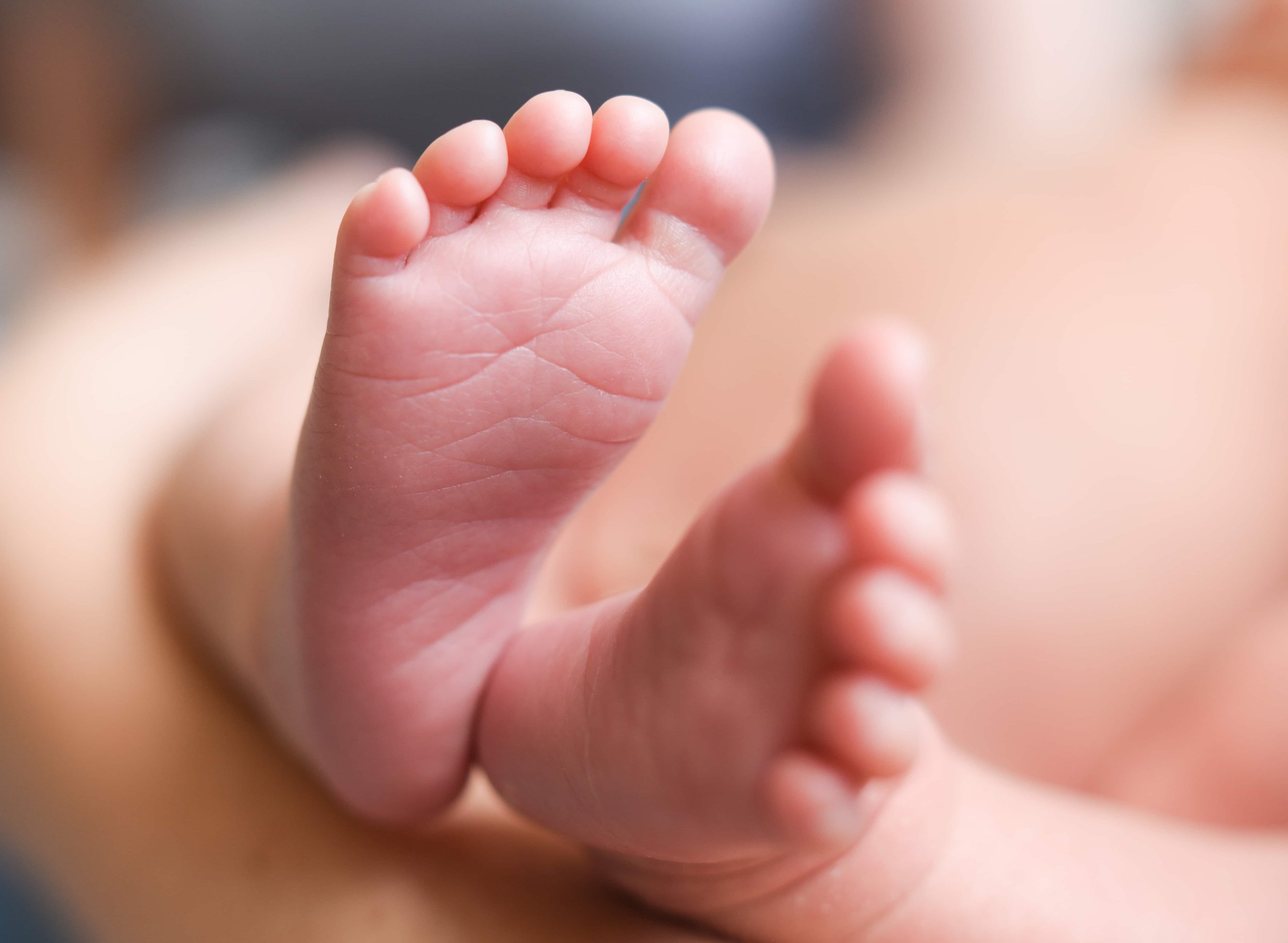 Natural and unposed close-up of newborn baby's feet