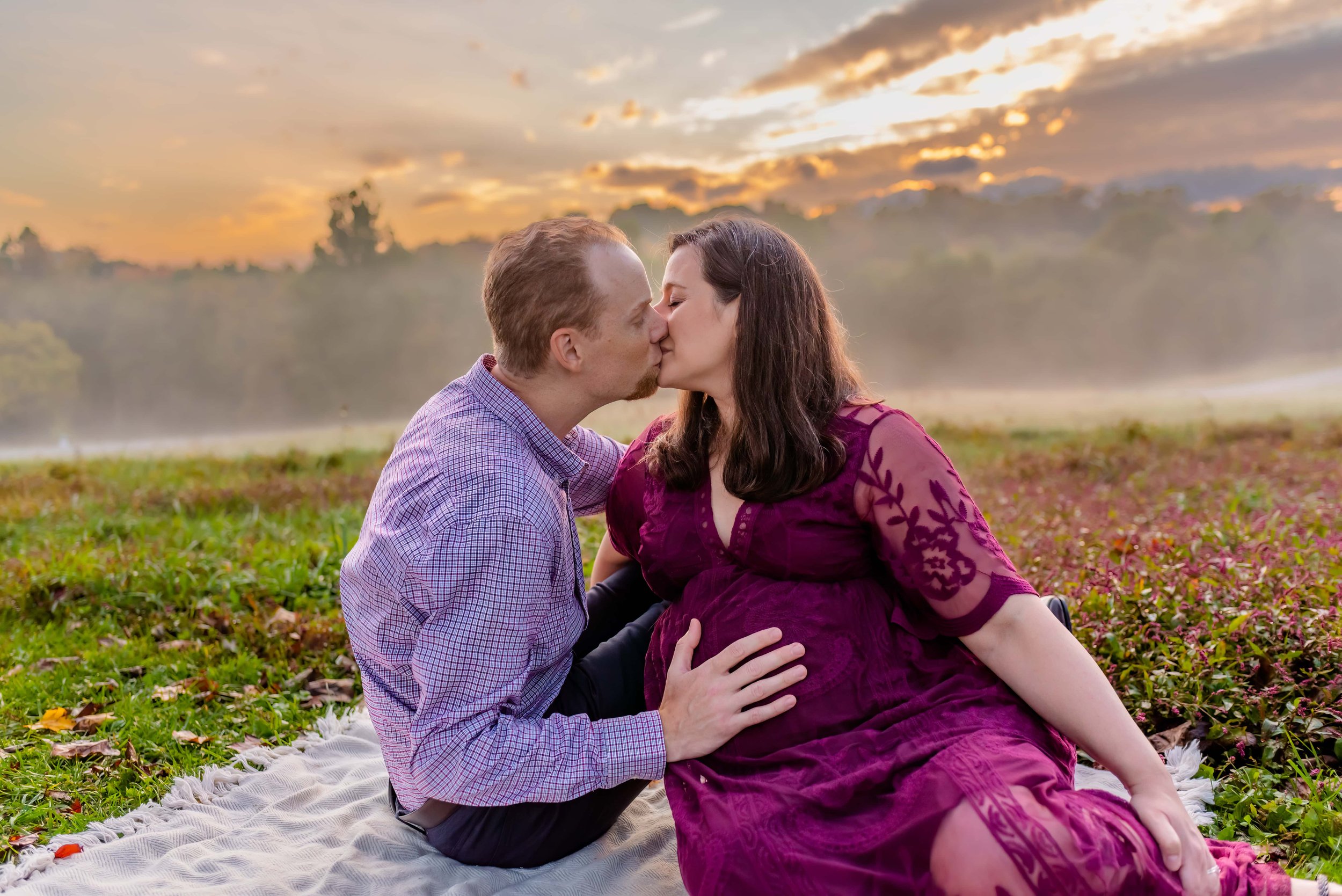 Maryland Maternity Photos - Husband and Wife Sitting in a Field Kissing