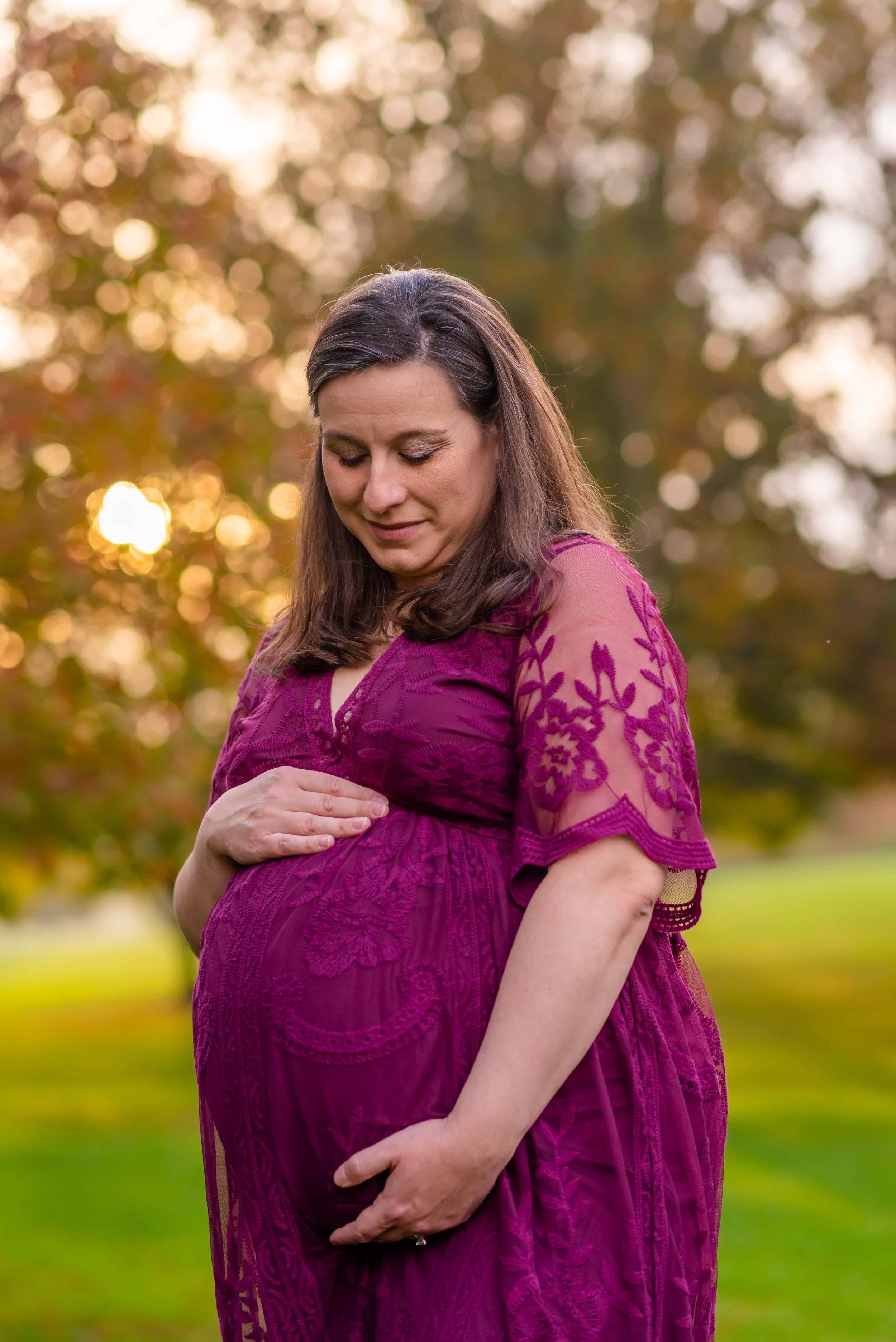 Maryland Maternity Photos - Pregnant woman looking down at her belly