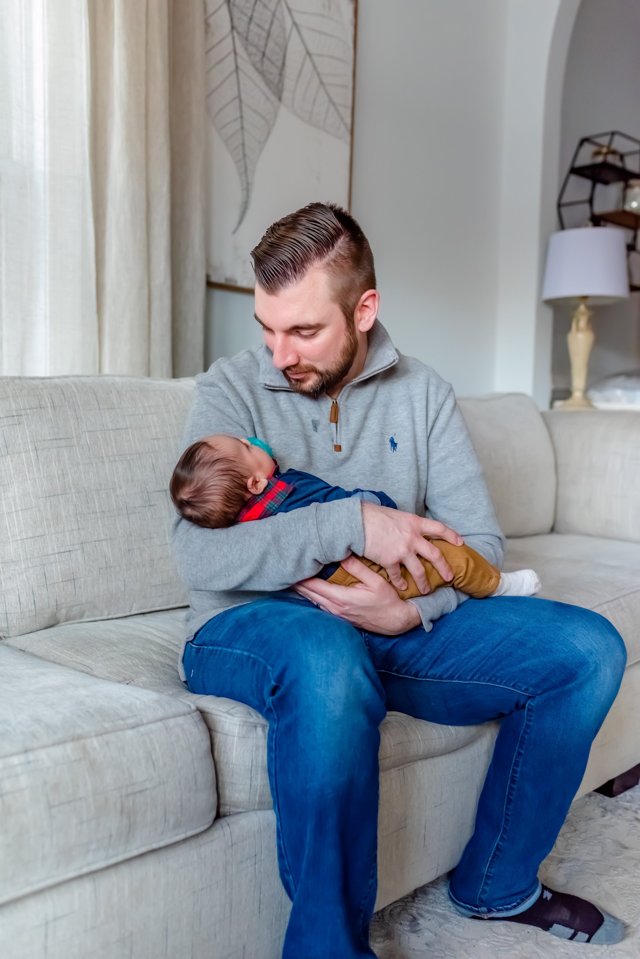 Maryland Newborn Photo with dad cradling baby 
