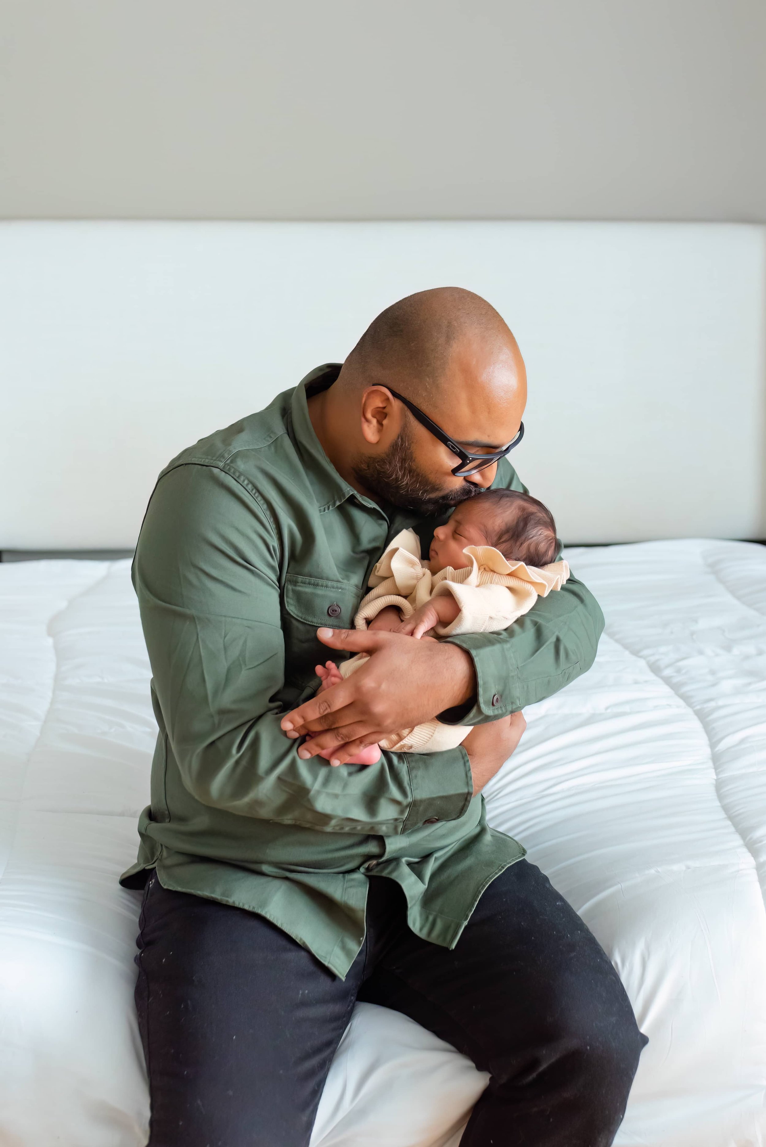 Maryland Newborn Photography - Dad Cradling and kissing baby 