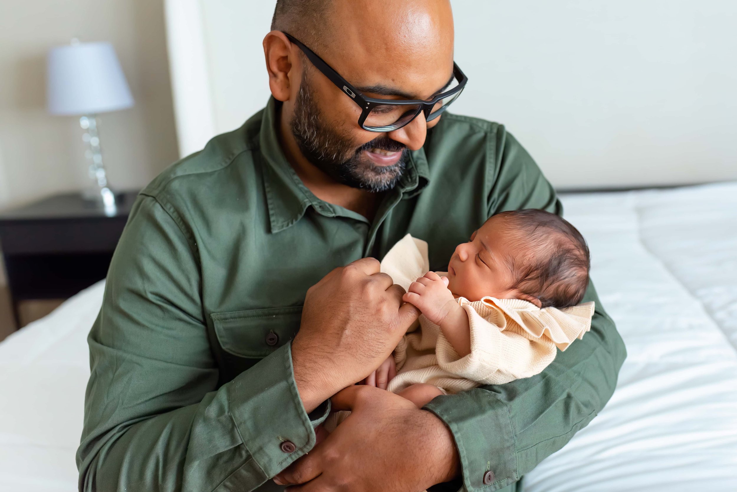 Maryland Newborn Photography - Dad Cradling and smiling at baby 