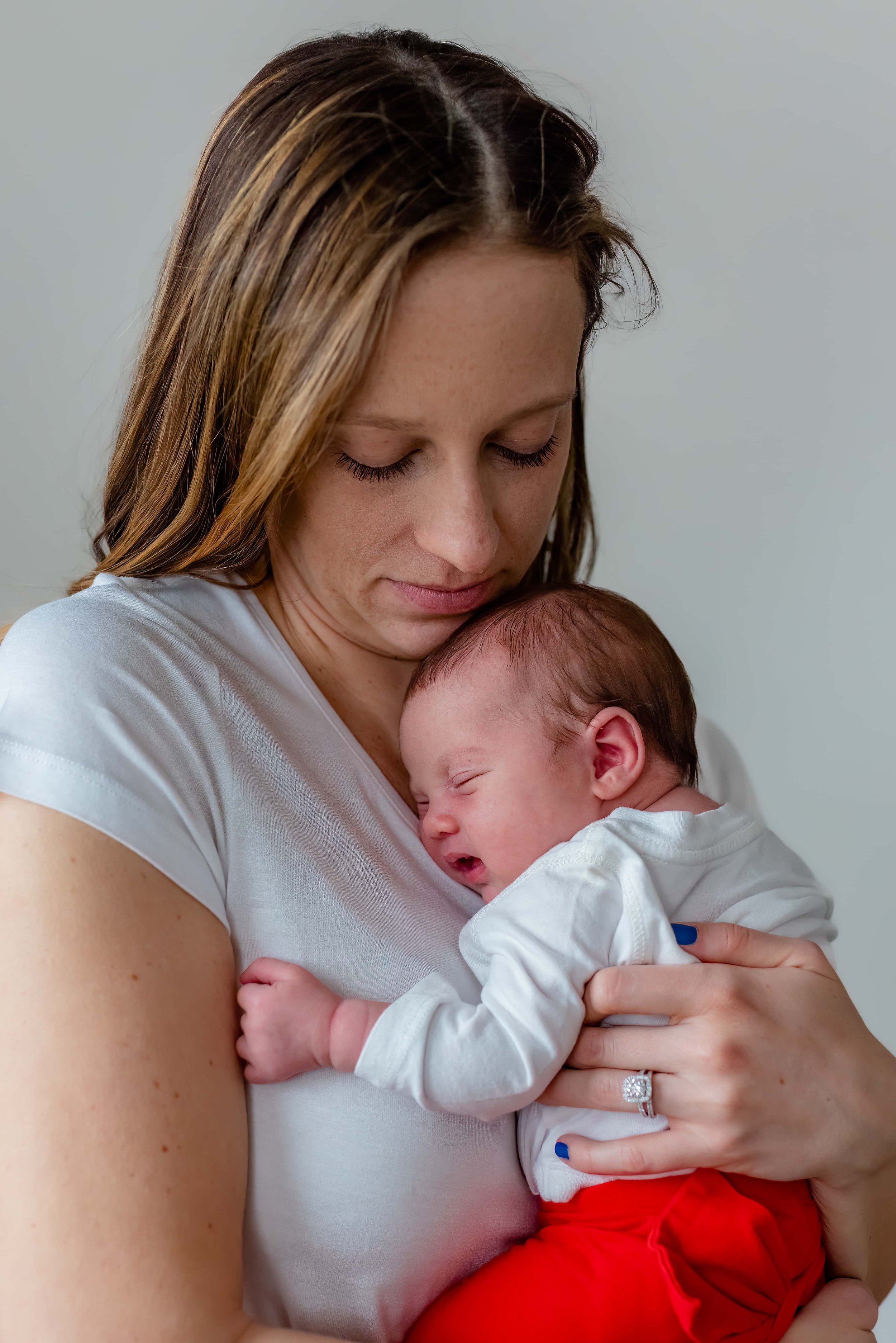 Maryland Lifestyle Newborn Photographer - mom holding baby on chest