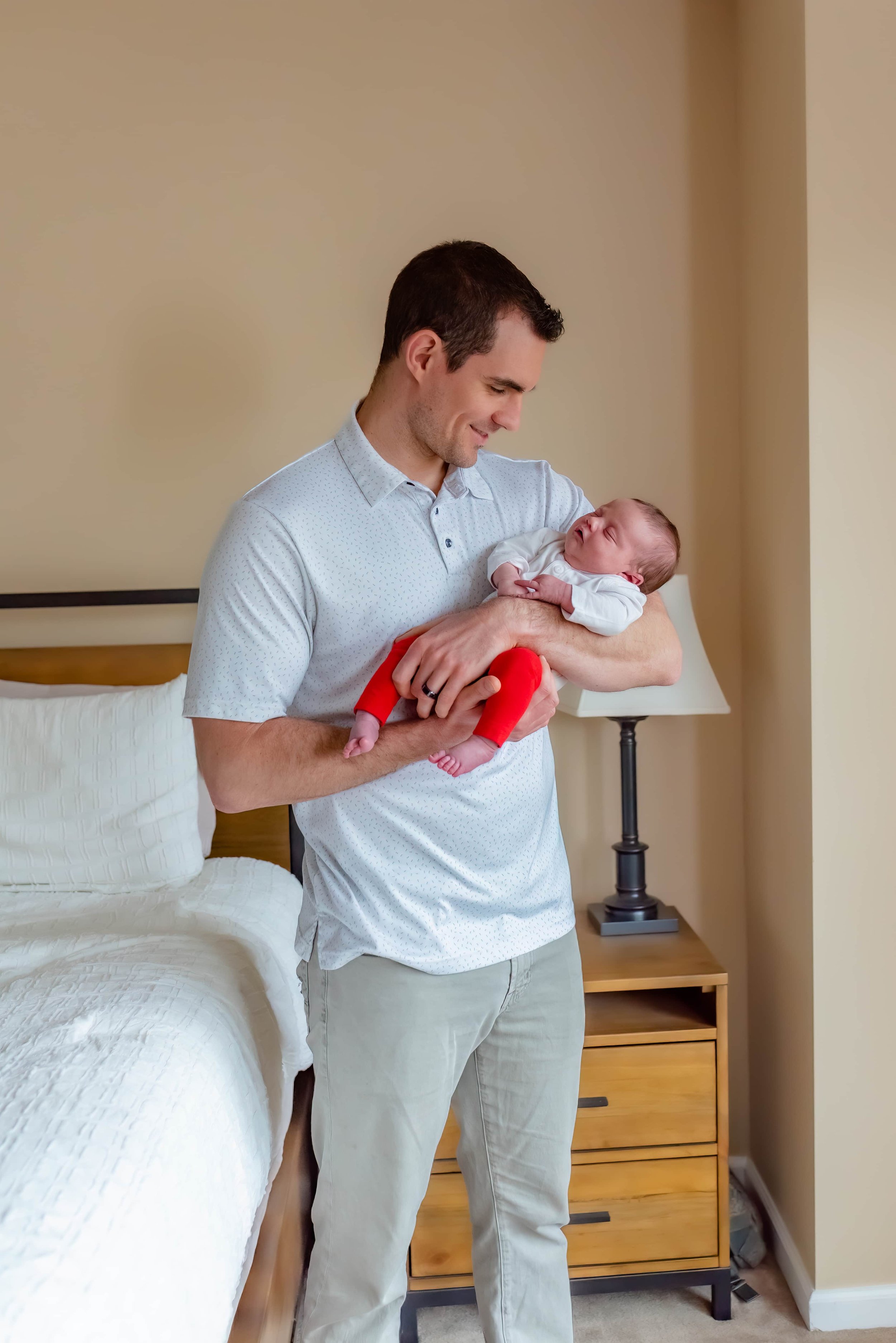 Maryland Lifestyle Newborn Photographer - Dad Cradling Baby