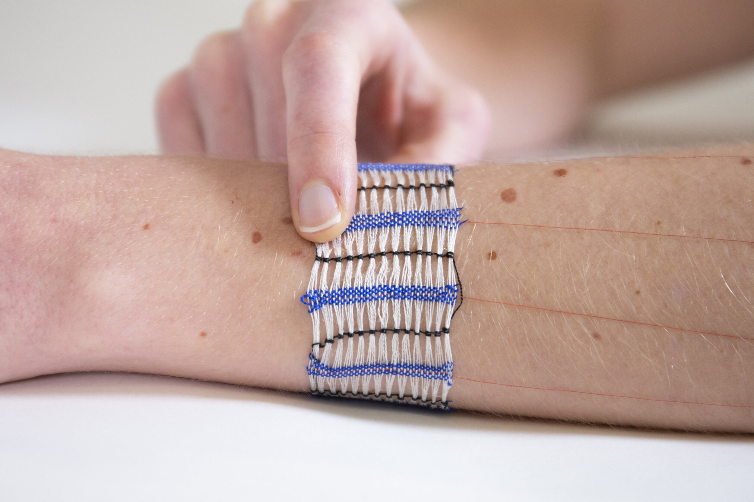  WovenSkin touch slider woven with an open space design that shows the wearer’s underlying skinmarks. (Image Credit: Hybrid Body Lab) (License: CC BY-NC-SA 4.0) 