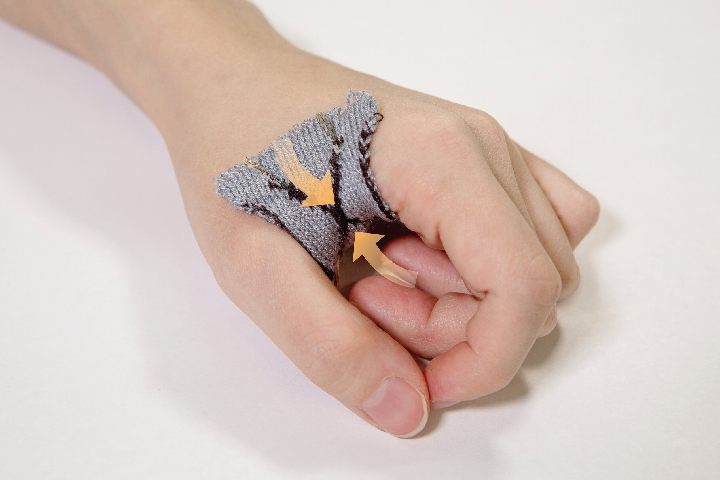  KnitDermis pinch interface during actuation while worn on the hand. (Image Credit: Hybrid Body Lab) (License:&nbsp;CC BY-NC-SA 4.0) 