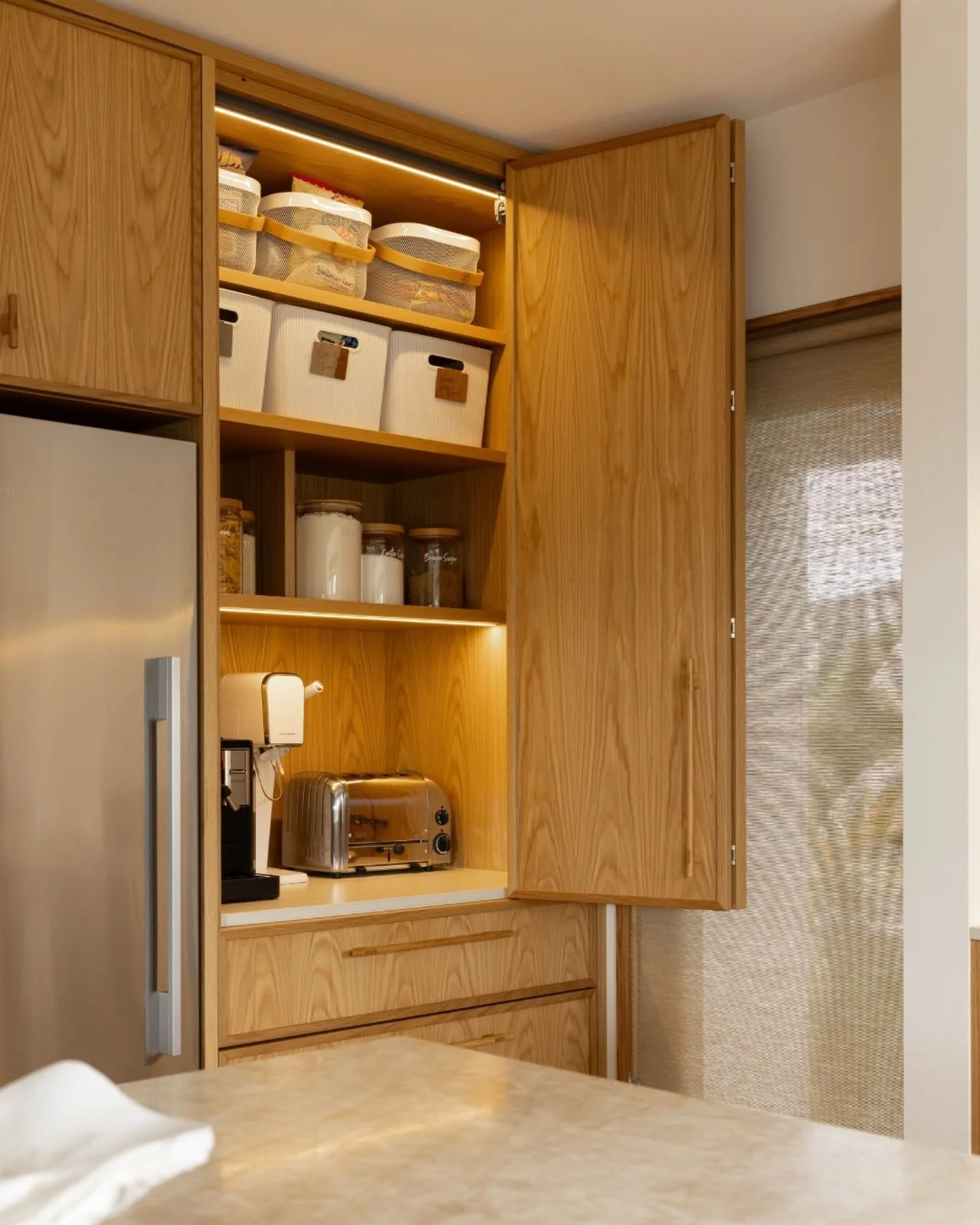 A dedicated snack-station pantry is concealed behind the smooth-gliding @hettichnz WingLine bifold doors, keeping everyday clutter neatly tucked away while staying easy to access when hosting. 

Yellowfox Designers: Andrea Burney &amp; Claire Bruford