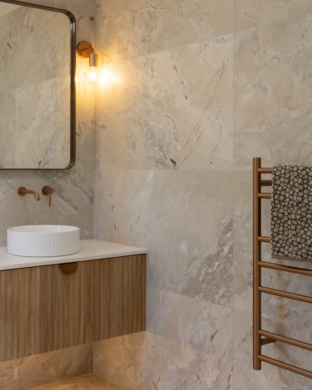 Project Profile: Vine Ave Residence 
At Vine Ave Residence, the bathrooms were designed to feel warm, calming, and effortlessly refined. 
The copper finishes such as the accessories and heated towel rails by @heirloom_int , are paired with neutral la