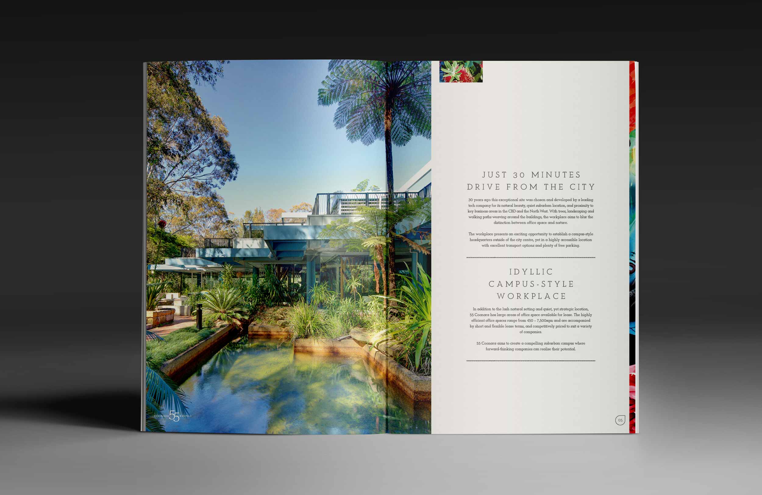 Open magazine showing a photograph of lush green trees, a small pond, and modern building structures, with text about a workplace located just 30 minutes from the city.