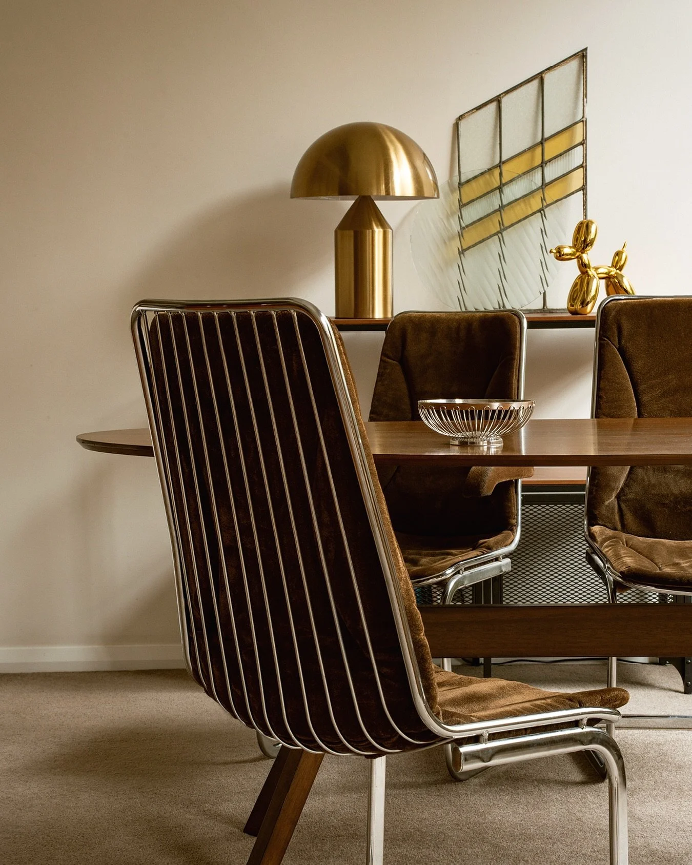 A quiet conversation between shapes and shadows. 
~ Mid-morning light on walnut grain
~ Velvet, brass, and glass in calm dialogue
~ Stillness held by warm reflections
Interior shot by me