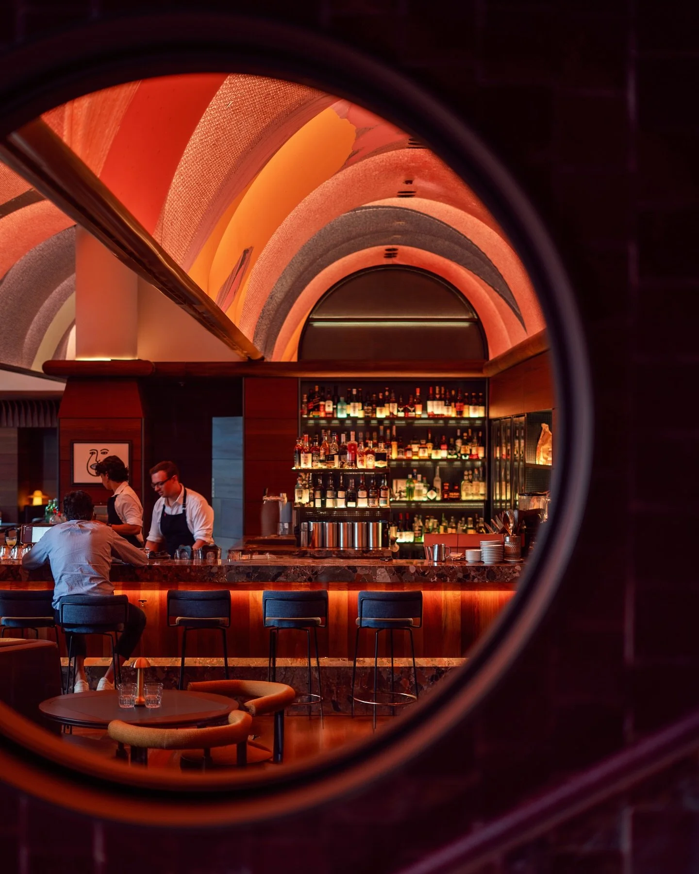 Framed through shadow and reflection of this venue newly awarded best bar design @barjulius.redfern 
~ Warm reds and deep ambers echo through the arches
~ Layered lighting revealing rhythm and geometry

📷by me
