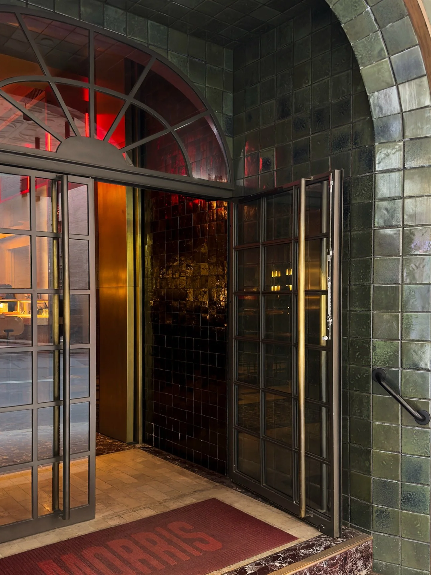 A threshold that sets the tone before you even step inside. @_morris_sydney 

~ Deep green glazed tiles holding the light
~ Warm red glow drawing the eye inward
~ Framed entry creating a sense of arrival

Photographing this was about capturing transi