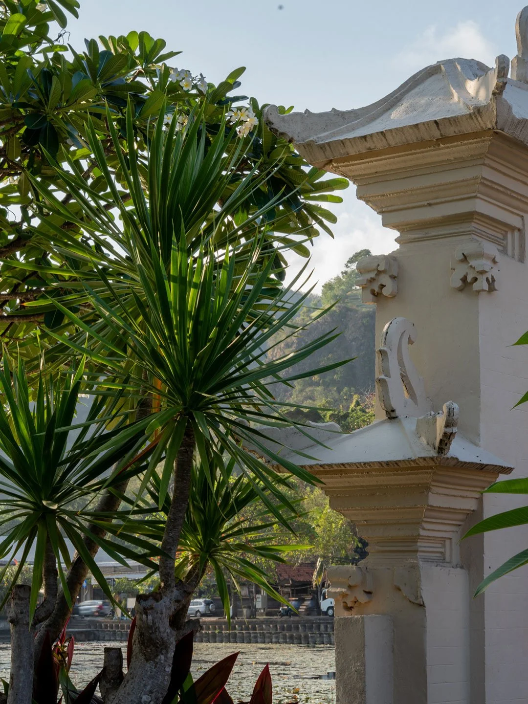 Balinese temple architecture framed by tropical plants