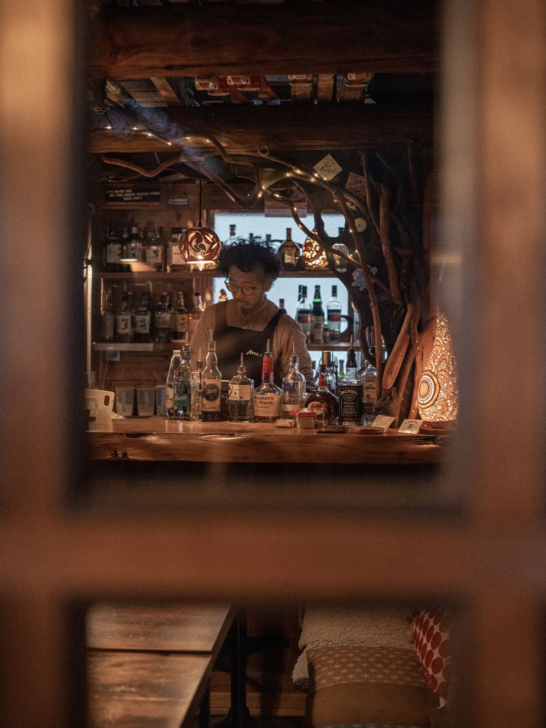 Cozy lodge bar viewed through wooden cabin window