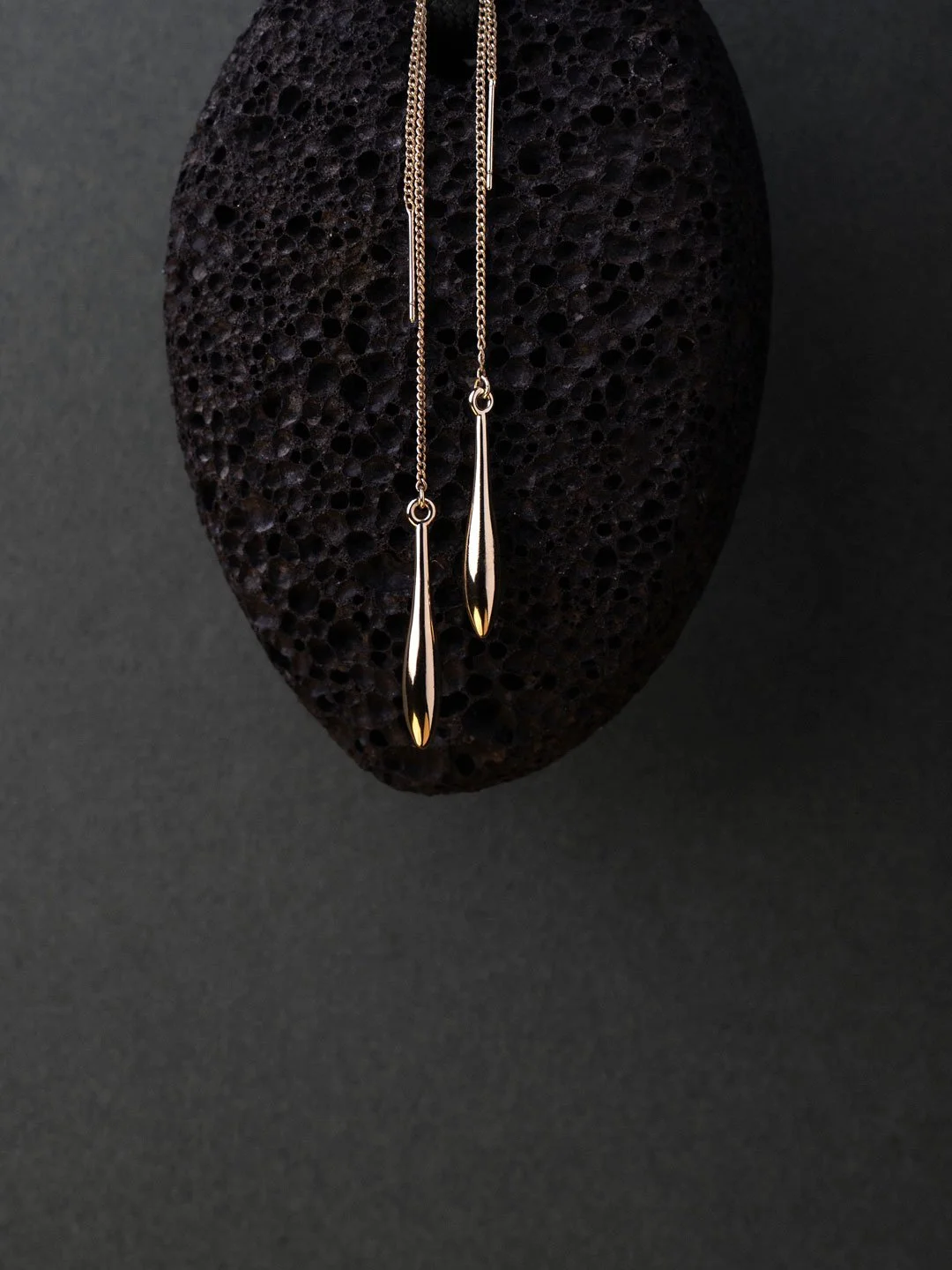 Jewellery editorial photography of earrings against stone