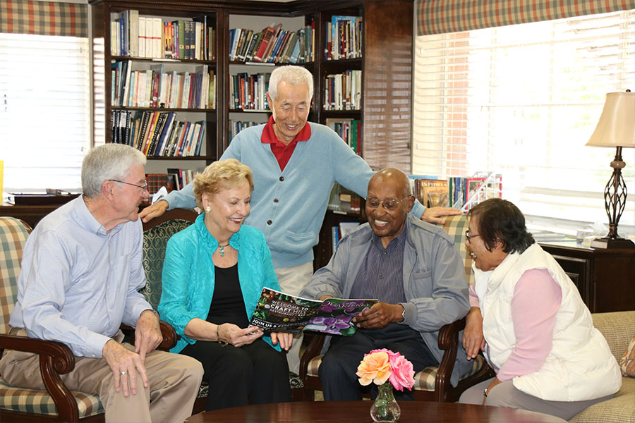 elderly group reading magazine inside library.jpg