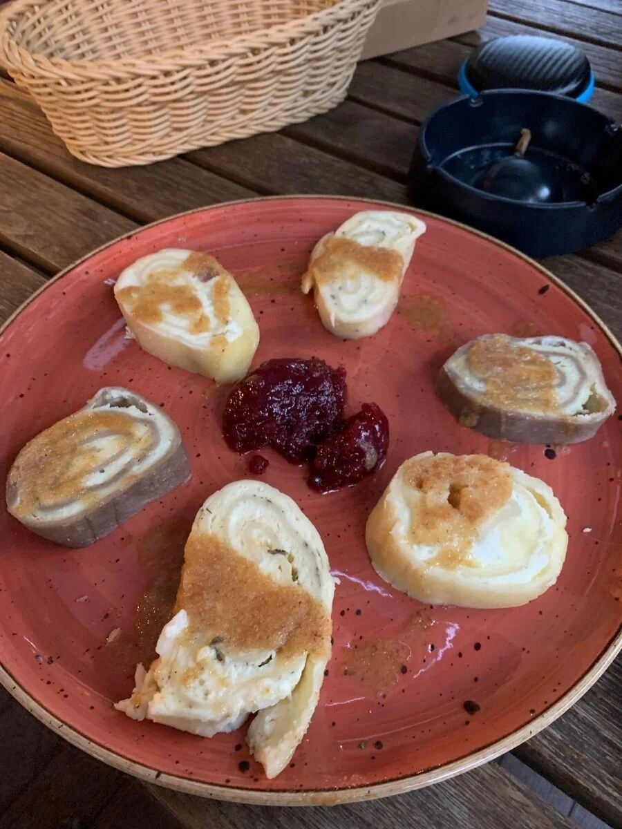 Traditional Slovenian Skutni Štruklji, buckwheat dough rolled with cottage cheese and topped with cinnamon and sugar.