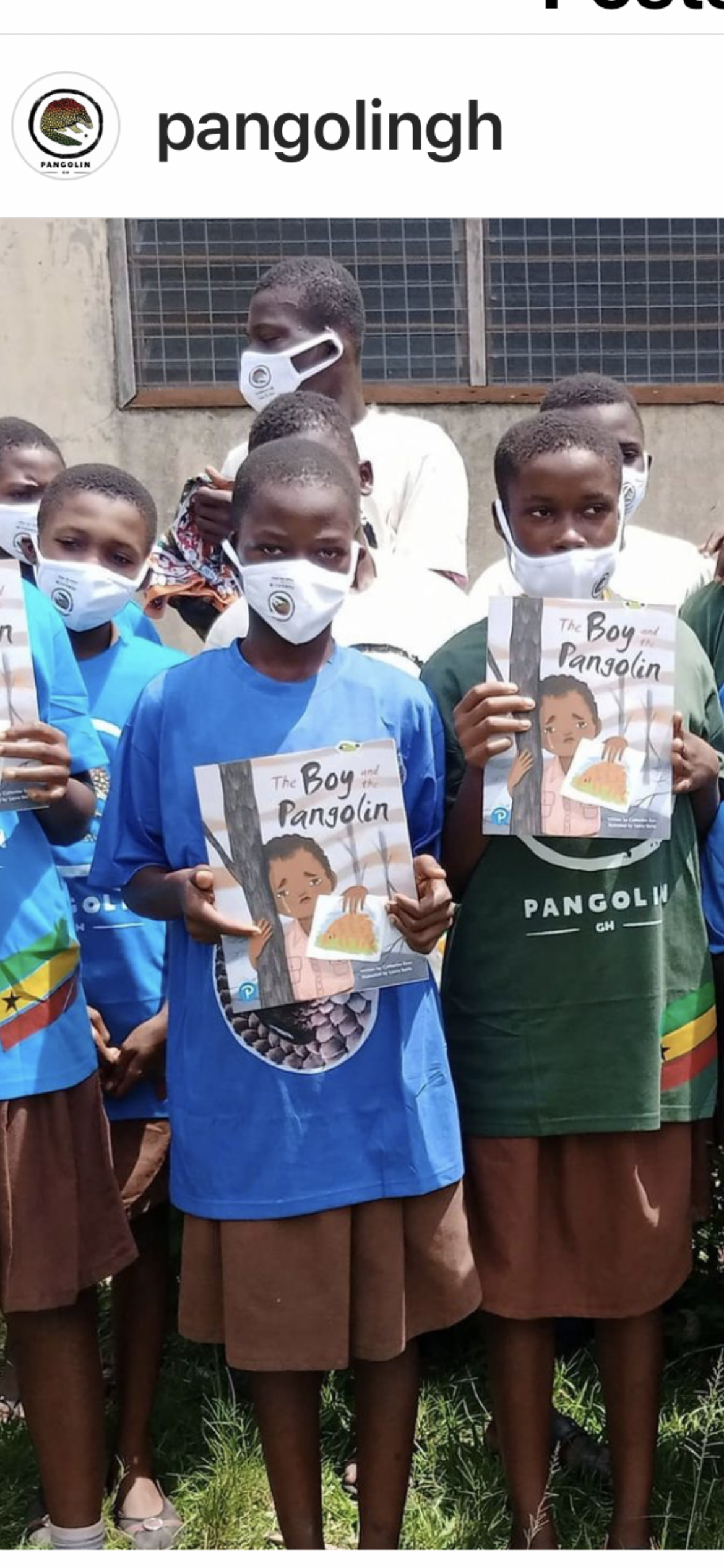 Children in Ghana holding a pangolin book