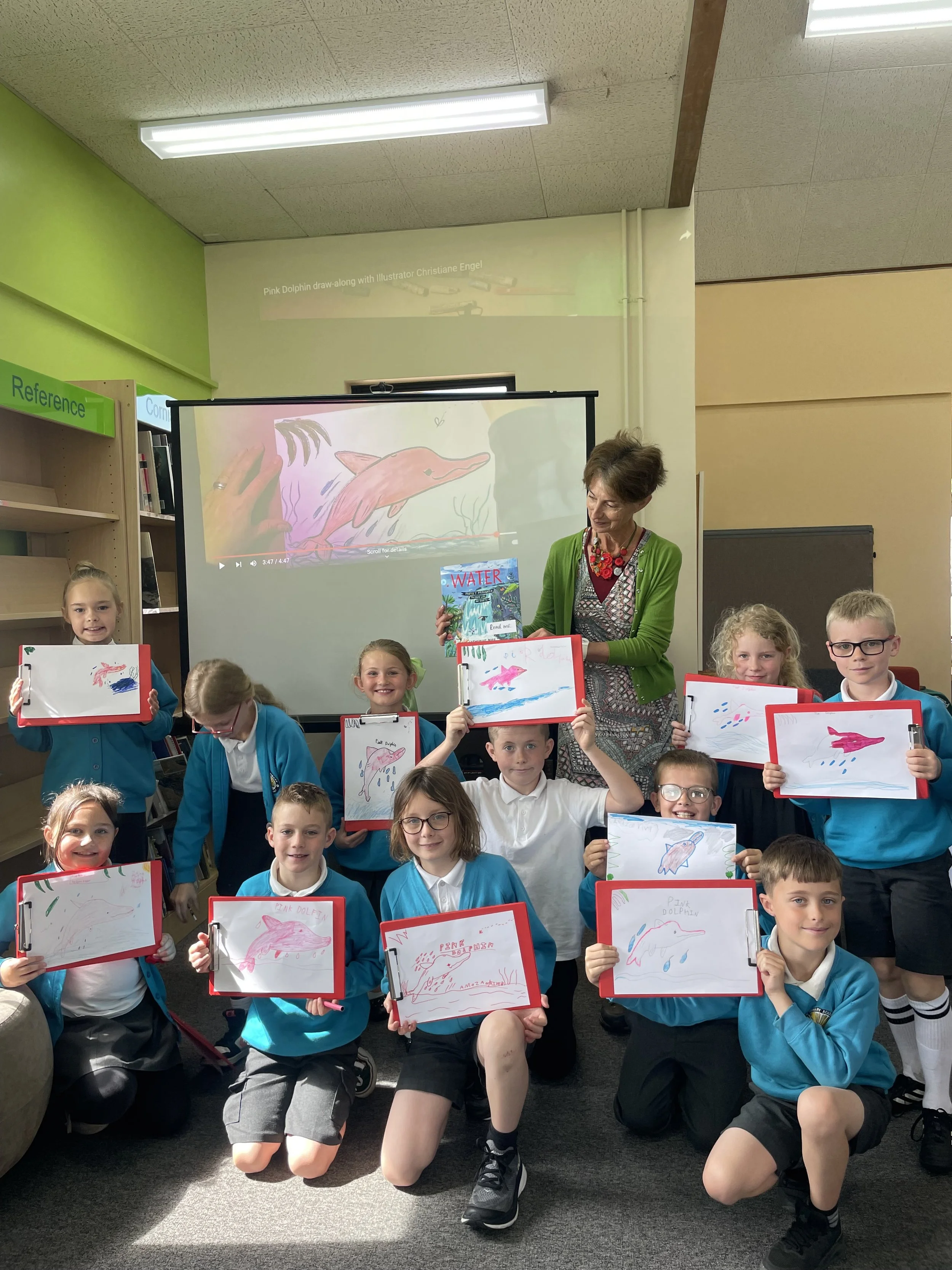 Catherine Barr author event with children sharing their drawings in Bude Library