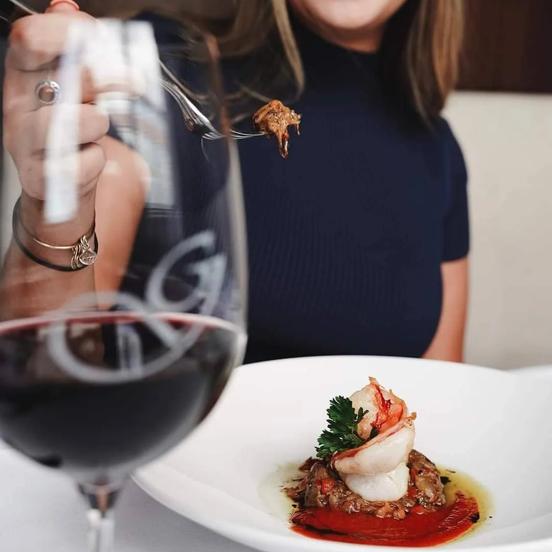 Fine dining experience at a restaurant with a private dining room, featuring gourmet seafood and red wine in an intimate, upscale setting — perfect for personal or corporate occasions