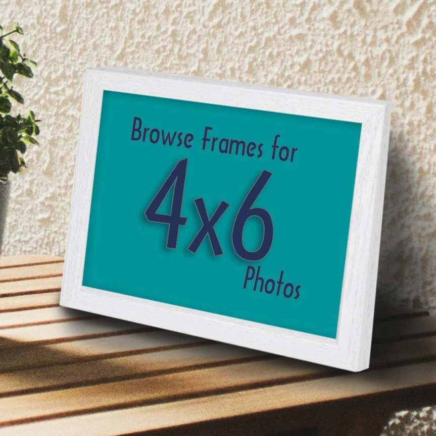 White tabletop frame on a wood table with the text "Browse Frames for 4x6 Photos"
