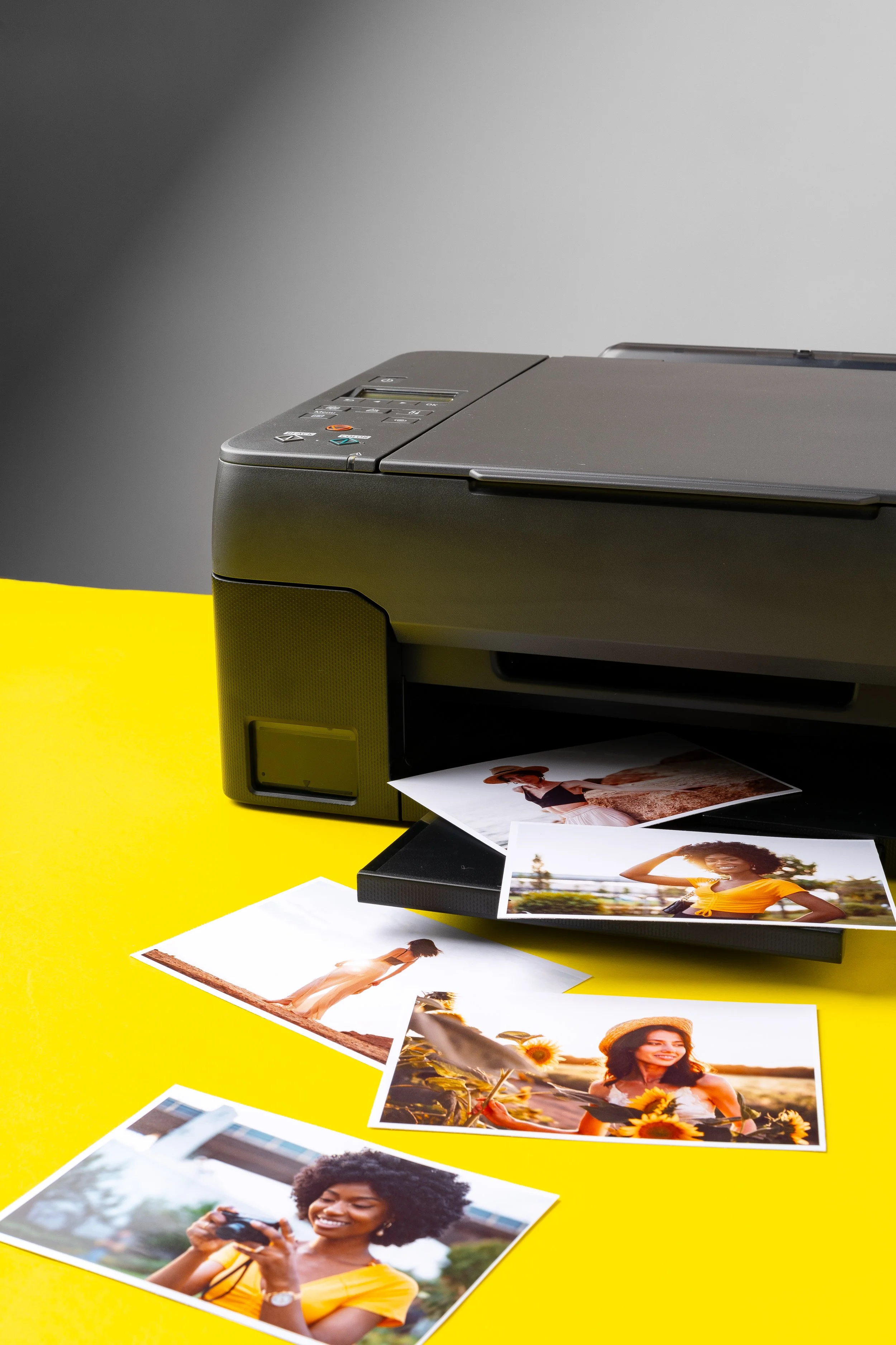 printer-printing-colorful-photos-people-close-up-yellow-background.jpg