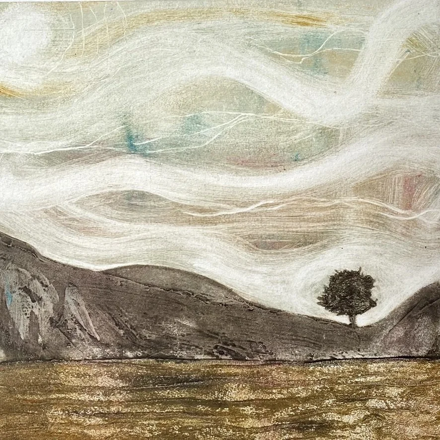 The usual view of Sycamore Gap in from the military road looking north. This one is from the other side featuring the steep crags against a wispy sky