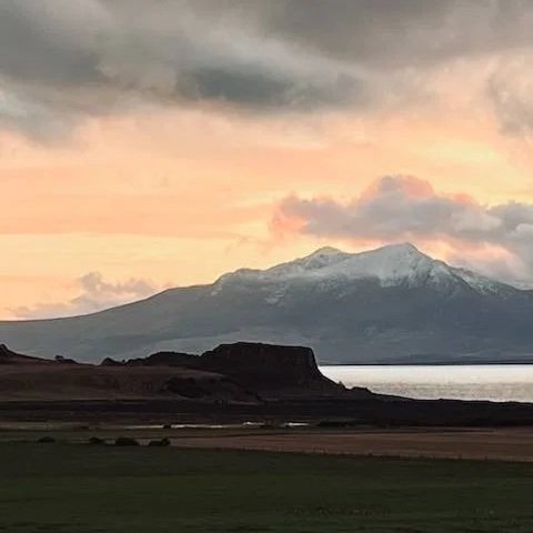 Dunagoil vitrified Iron Age fort silhouetted against Arran Isle of Bute
