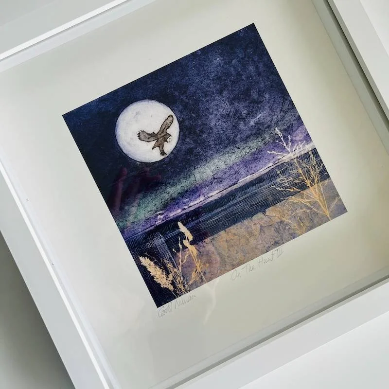 An open edition landscape art print in a white box frame featuring an owl against full moon on the hunt - Indigo and manganese blue sky - abstract foreground with mauves and blue greens highlights
