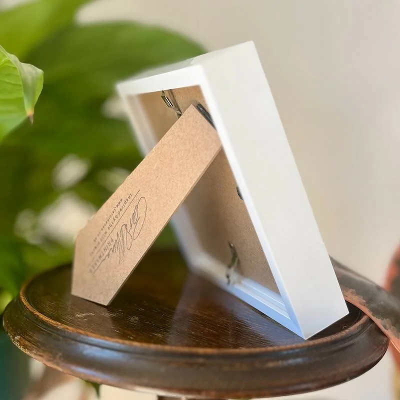 back of a white box frame on a shelf