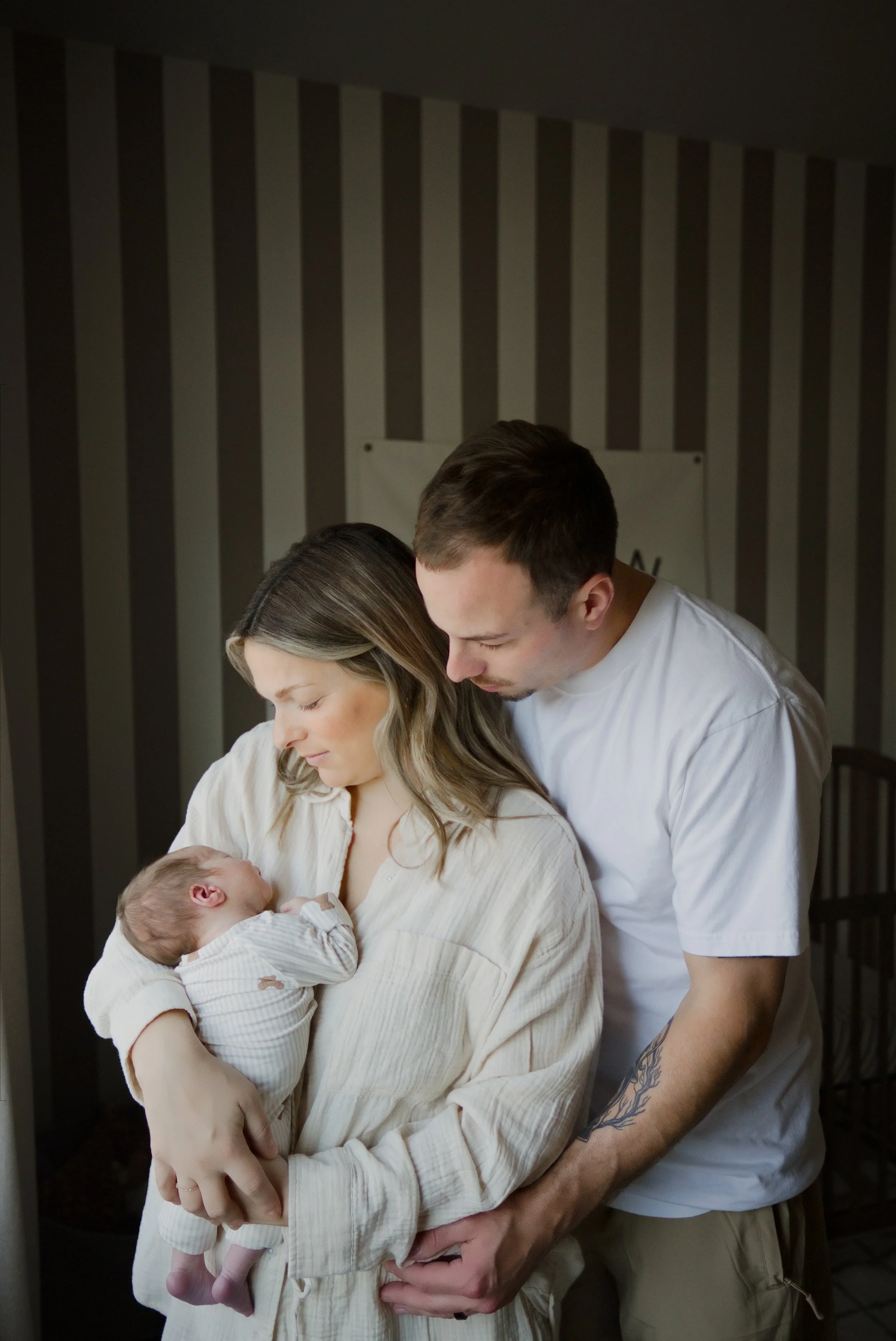Parents admire their newborn together in the nursery, photographed by an Estacada newborn photographer