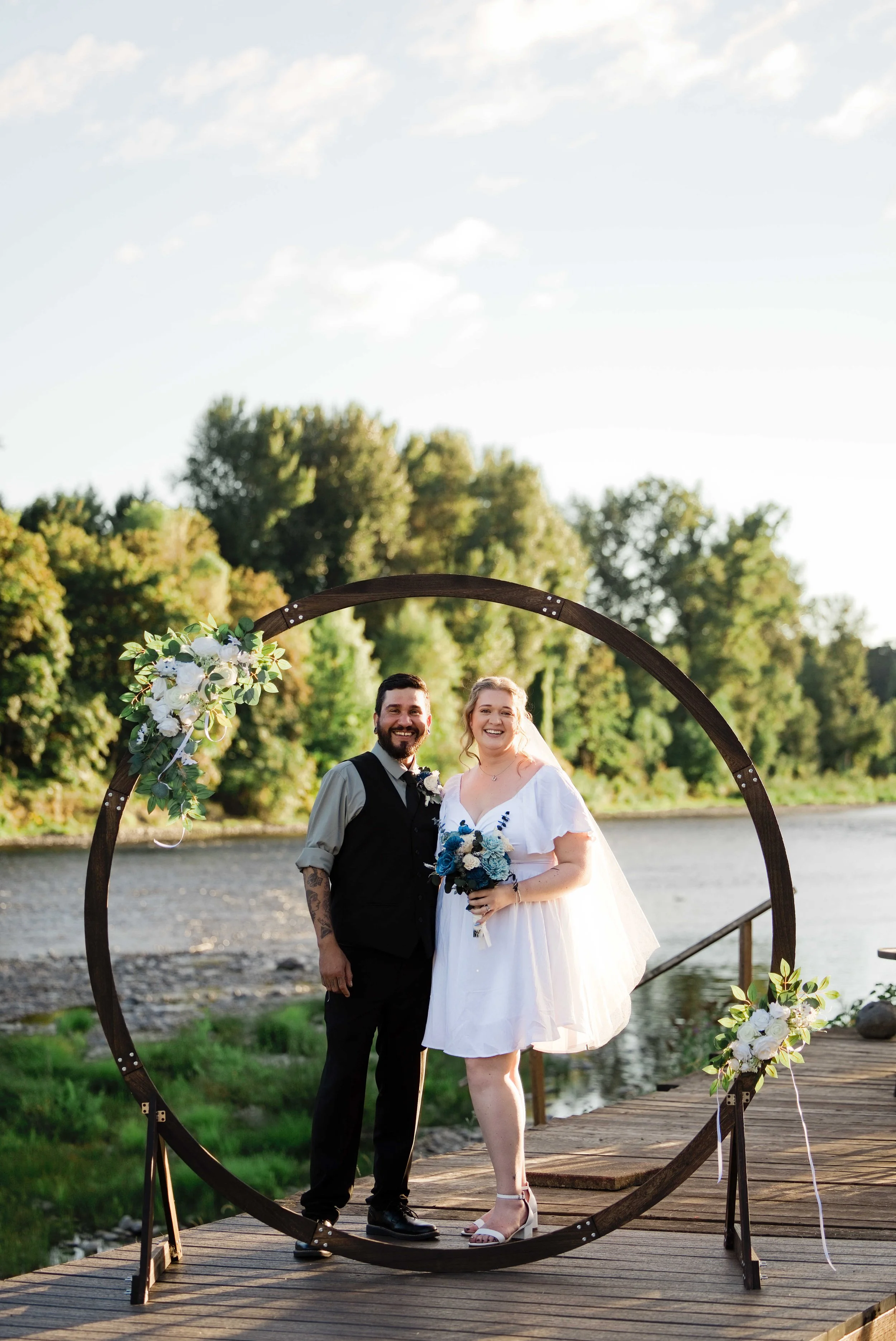 The newlyweds under the circle arch at their backyard wedding, Clackamas River wedding photographer