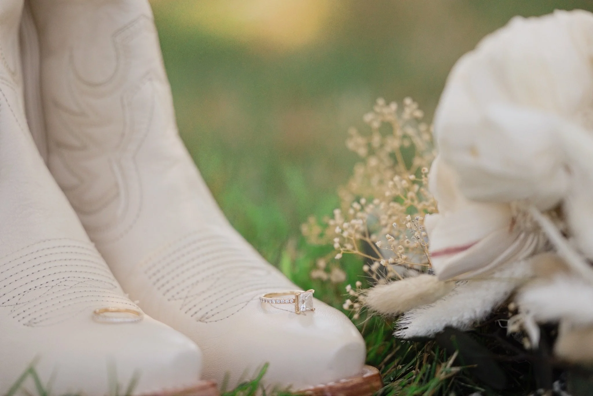 The bride's lace heels beside white flowers on the grass