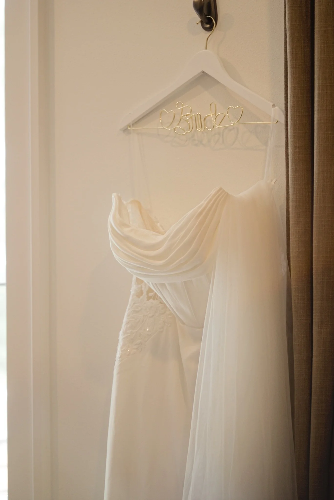 Sarah's wedding dress hanging in the window