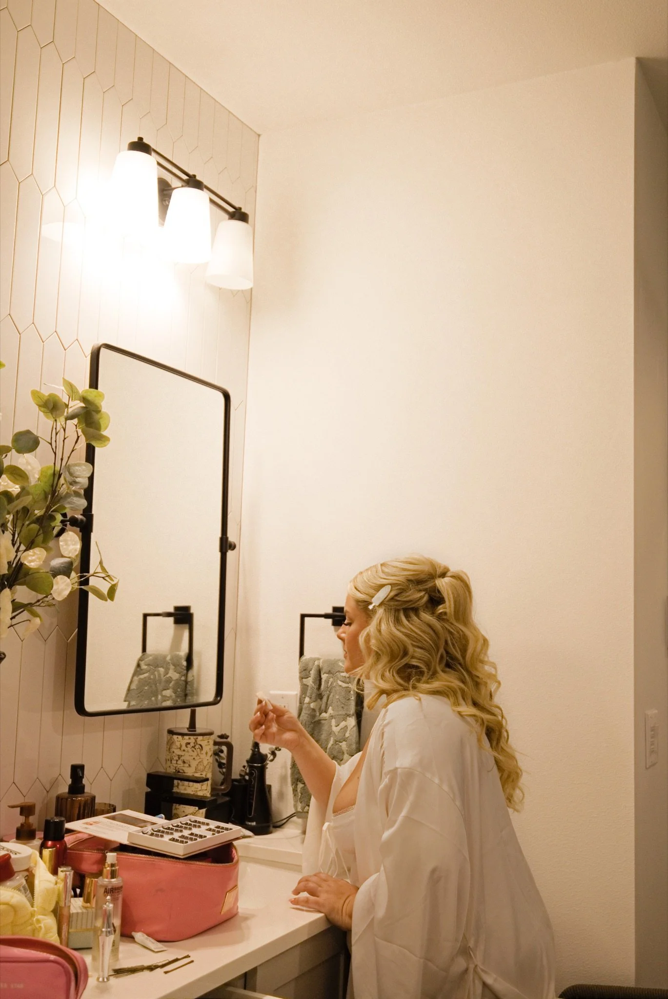 Sarah getting ready in the bathroom mirror