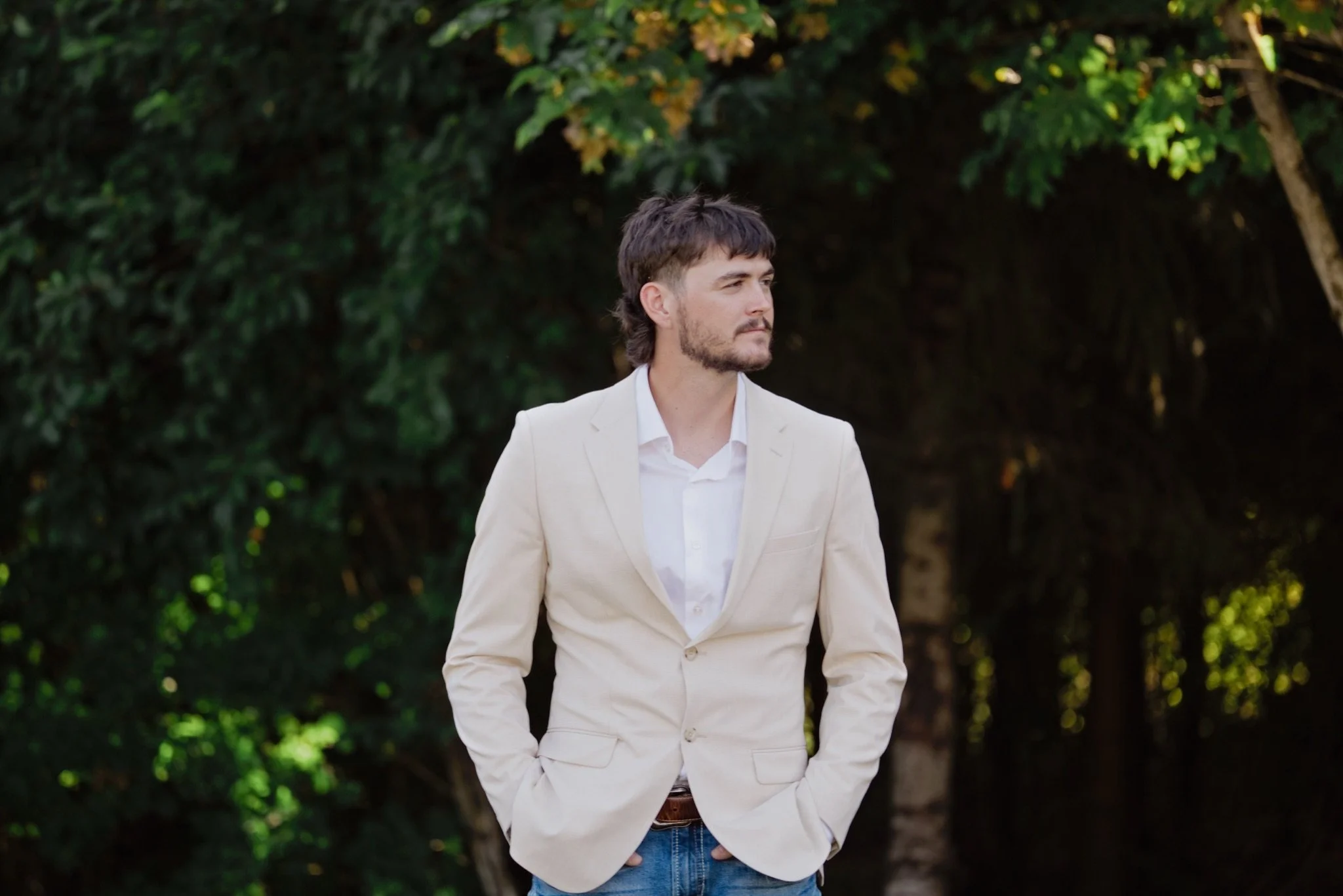 Reed in his cream suit waiting under the trees