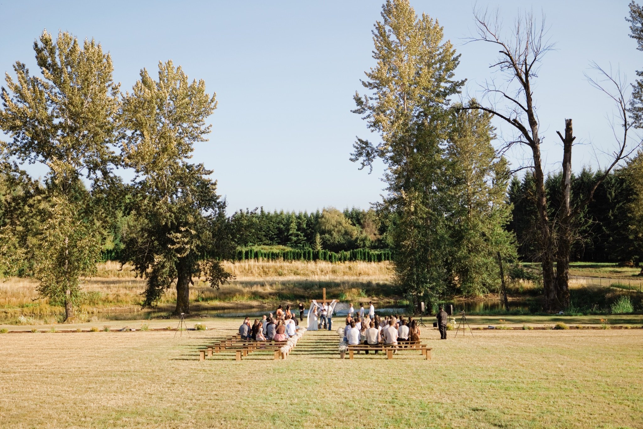 The ceremony in the backyard meadow seen from the hillside, Sandy Oregon wedding photographer