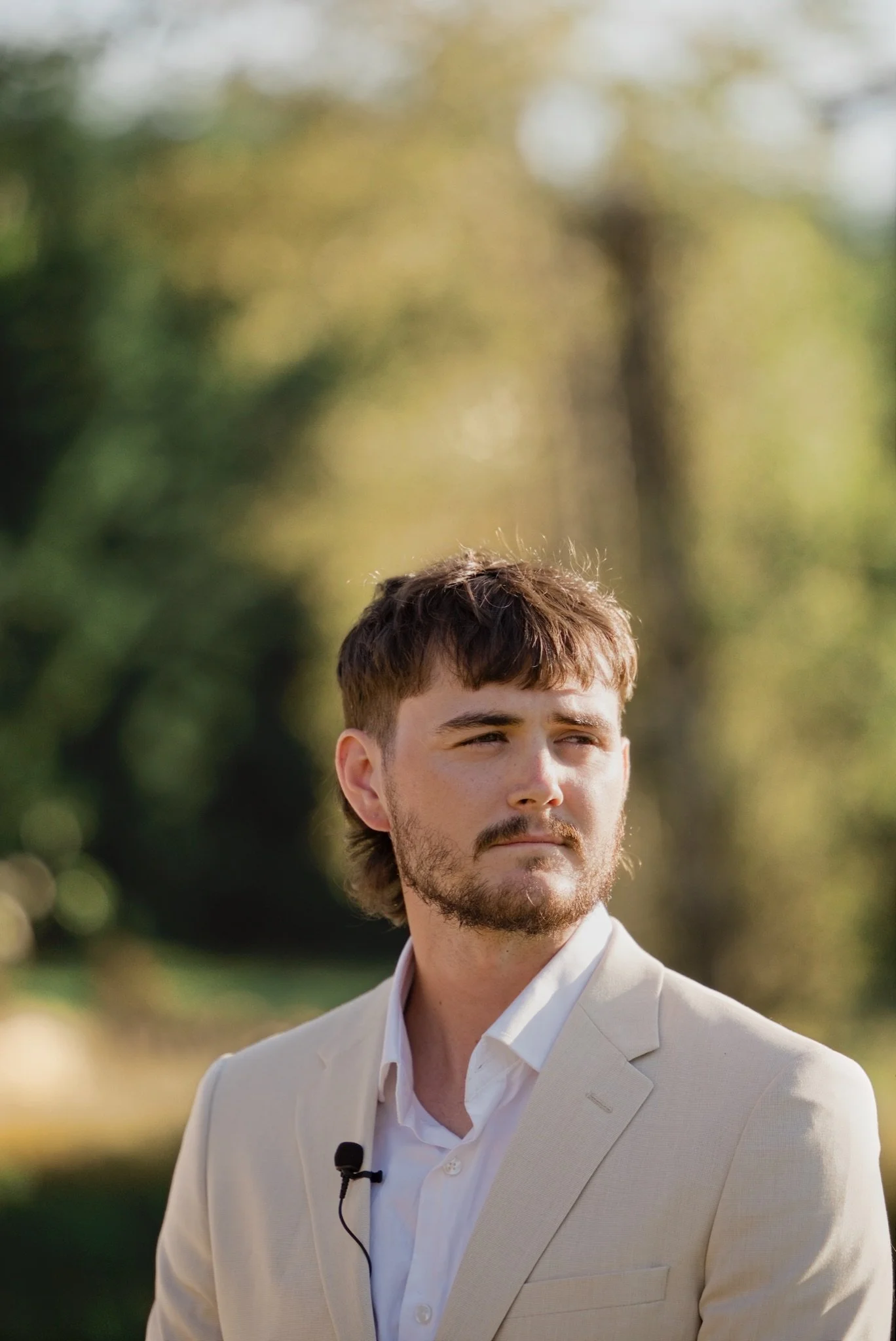 Reed smiling as he waits for Sarah at the altar