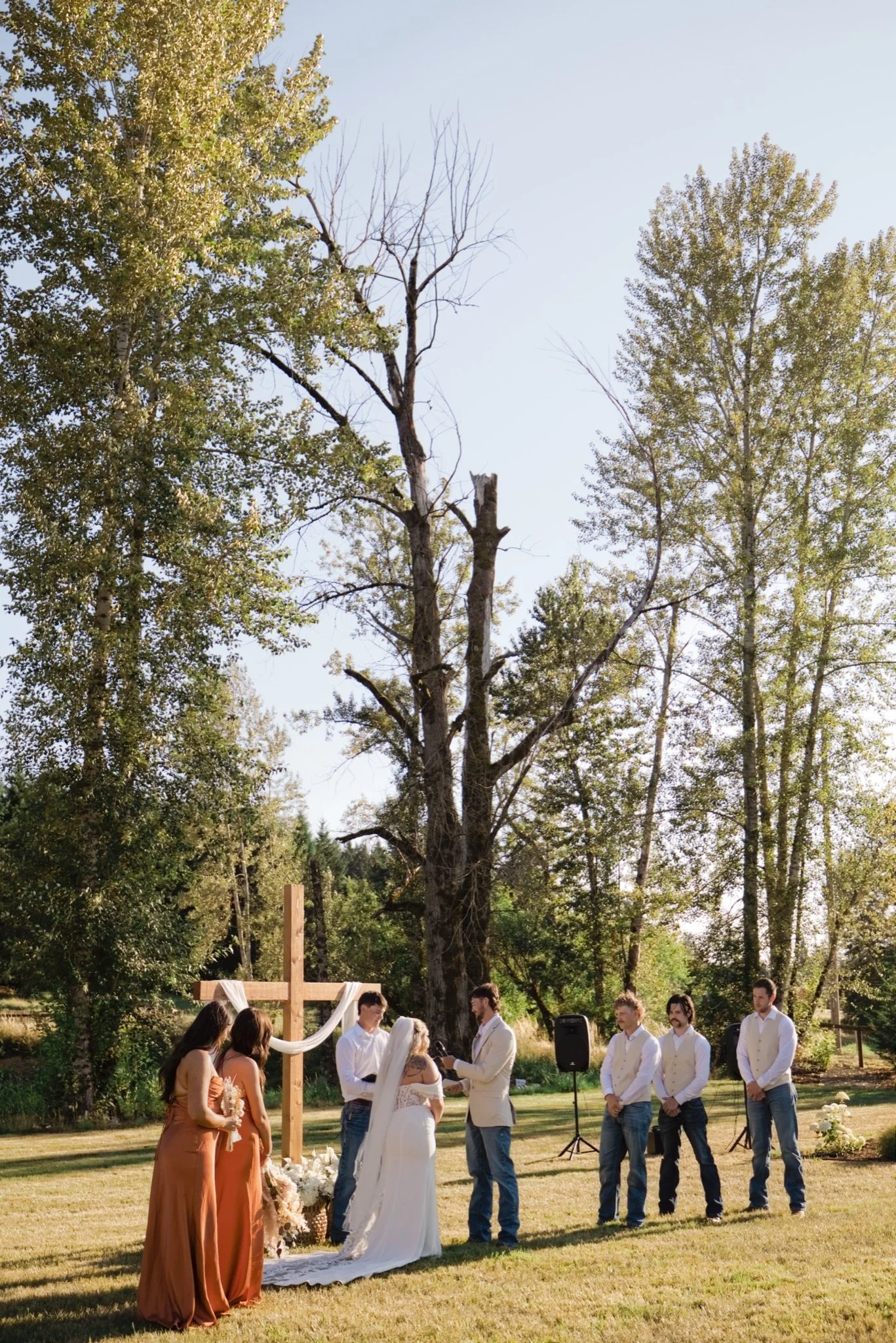 Sarah and her dad walking down the aisle through the meadow