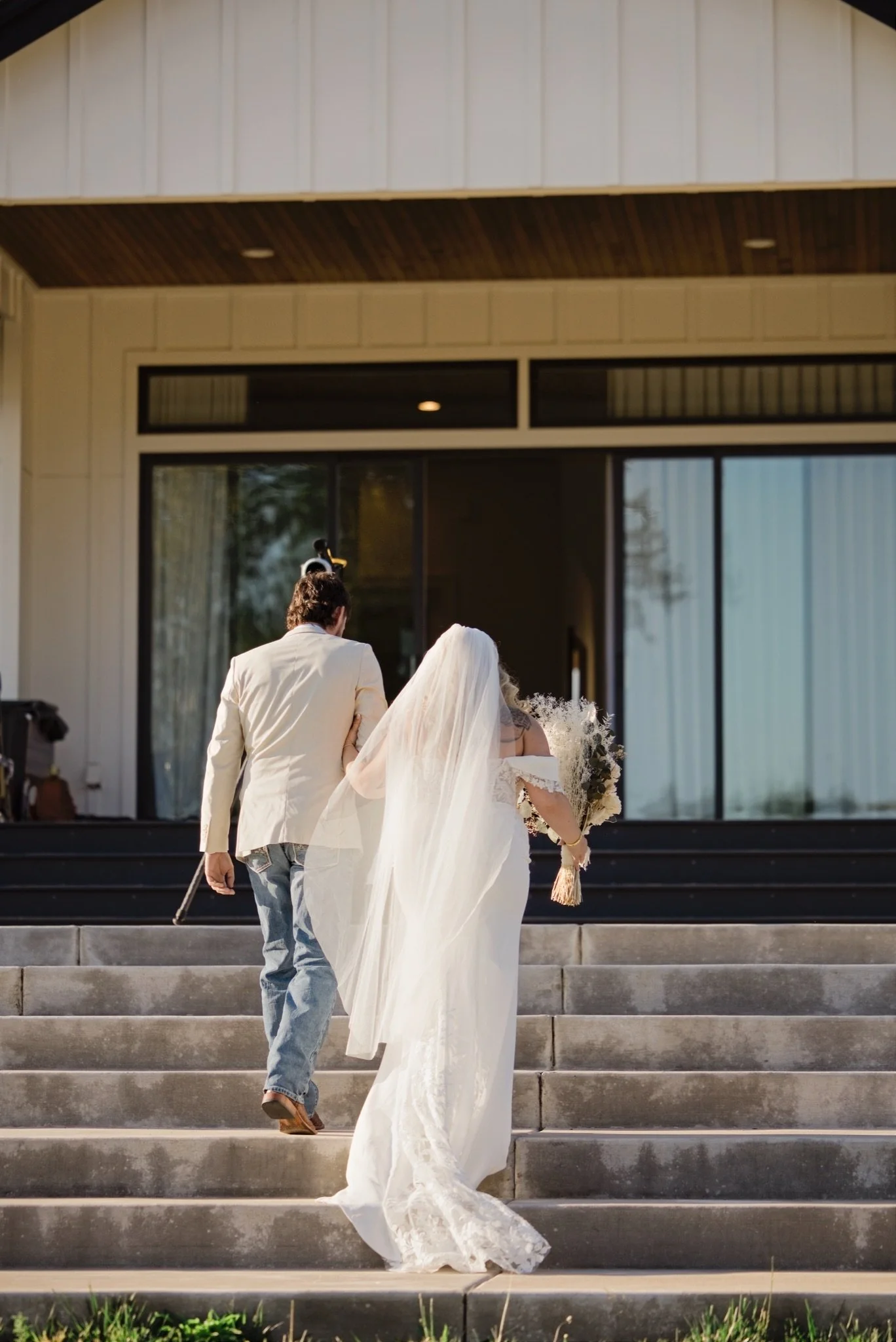 Sarah and Reed walking up the steps as newlyweds
